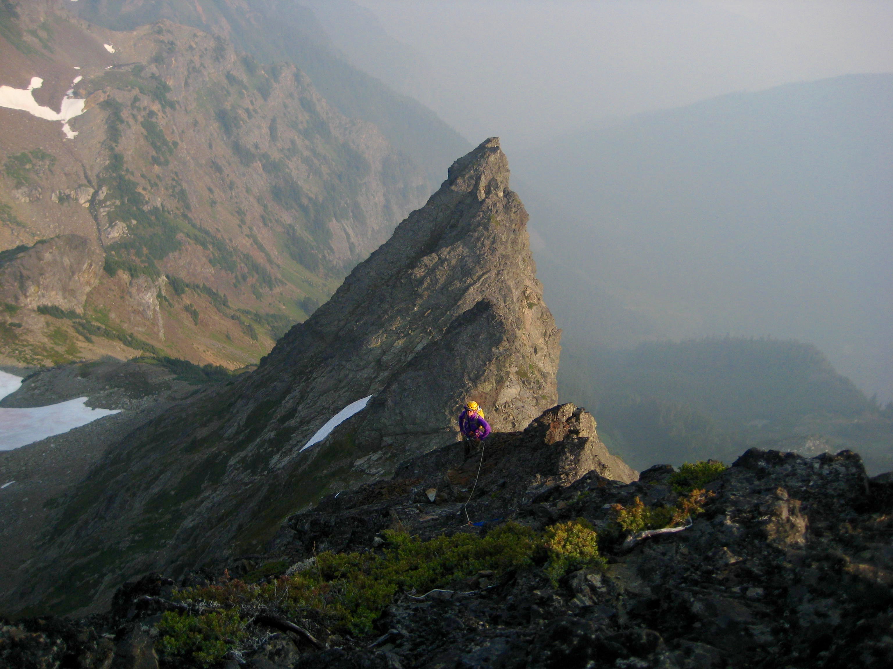 Climbers scrambling down the rock on the south ridge of Baby Munday Peak