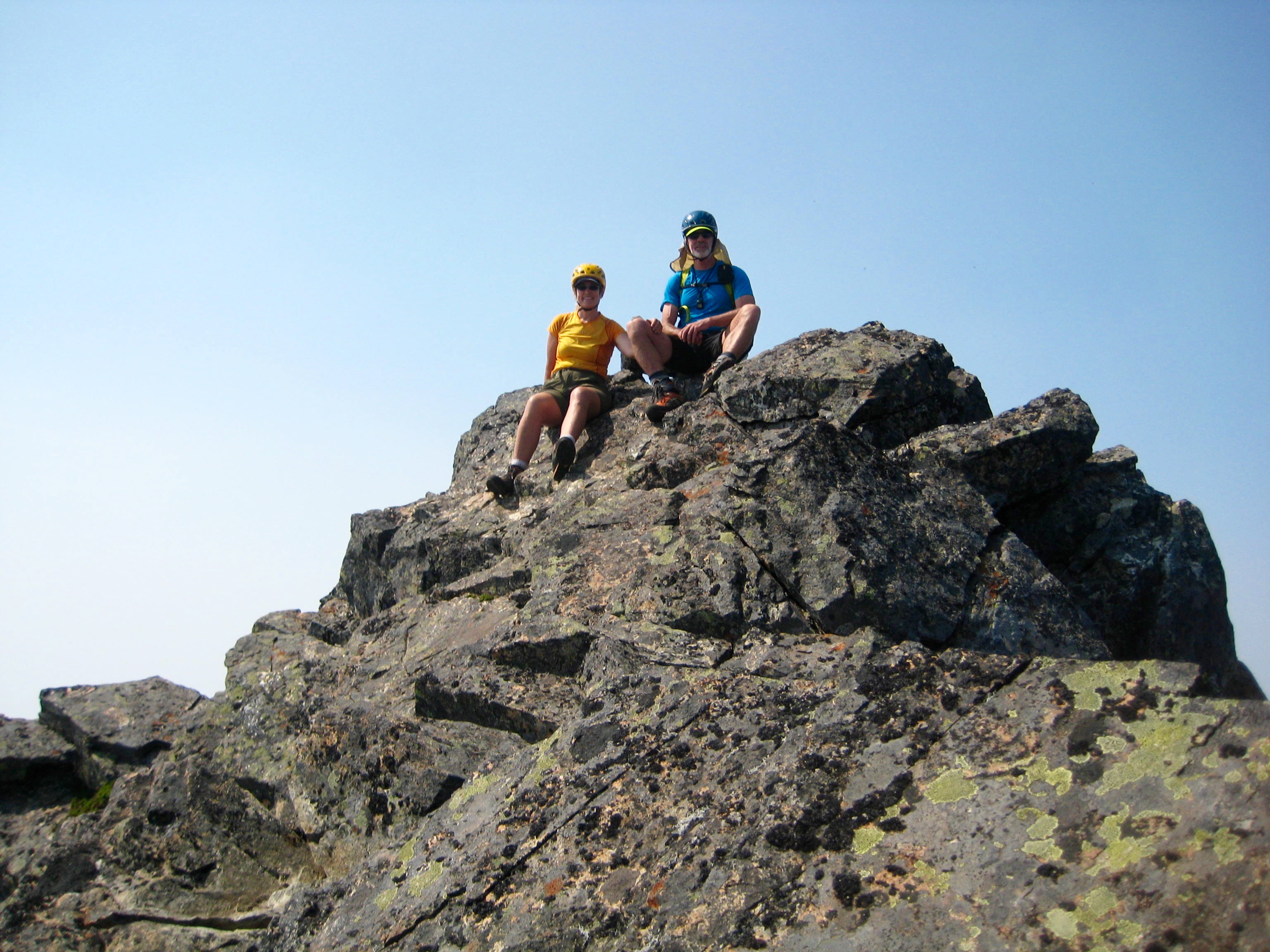 mountain climbers sitting on the bouldery summit of Knight Peak in the Cheam Range
