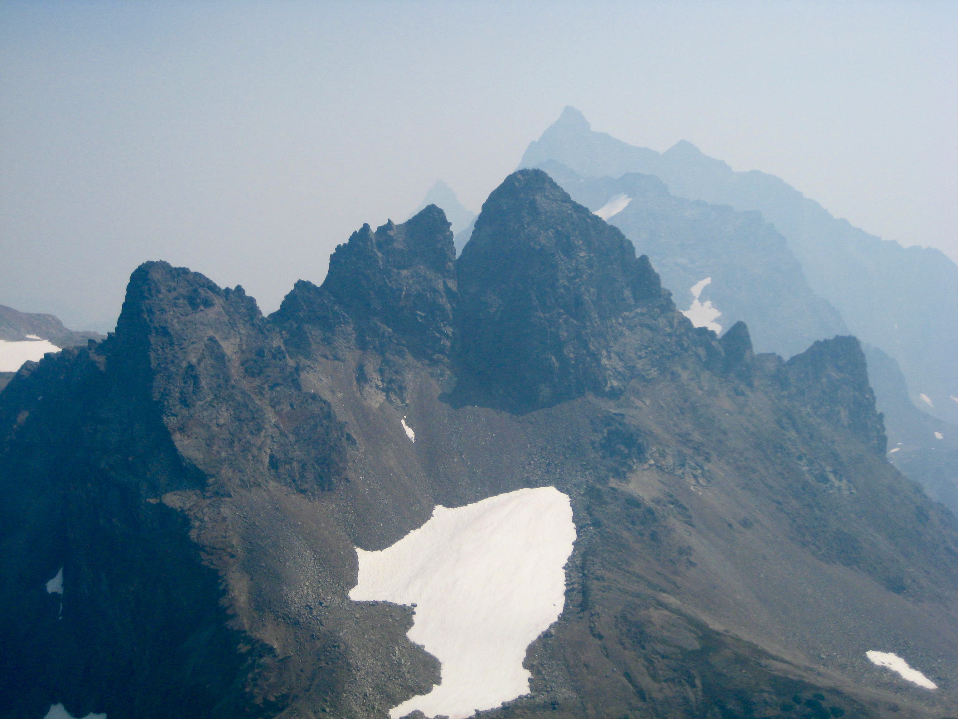 Baby Munday Peak and Welch Peak in the smokey air From Knight Peak in the Cheam Range
