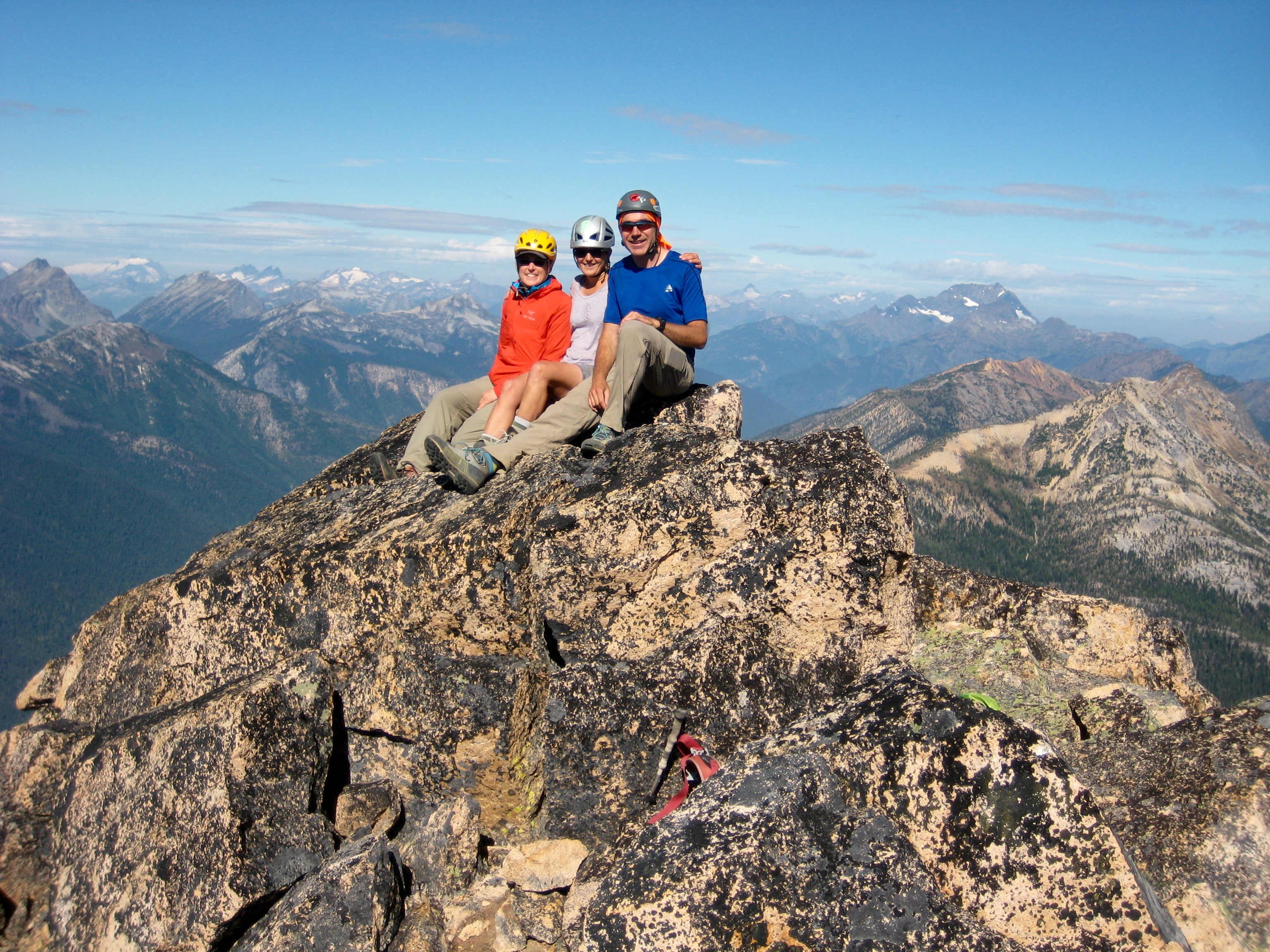 mountain climbers on the rocky summit of Mt Hardy with the Methow Mountains in the background