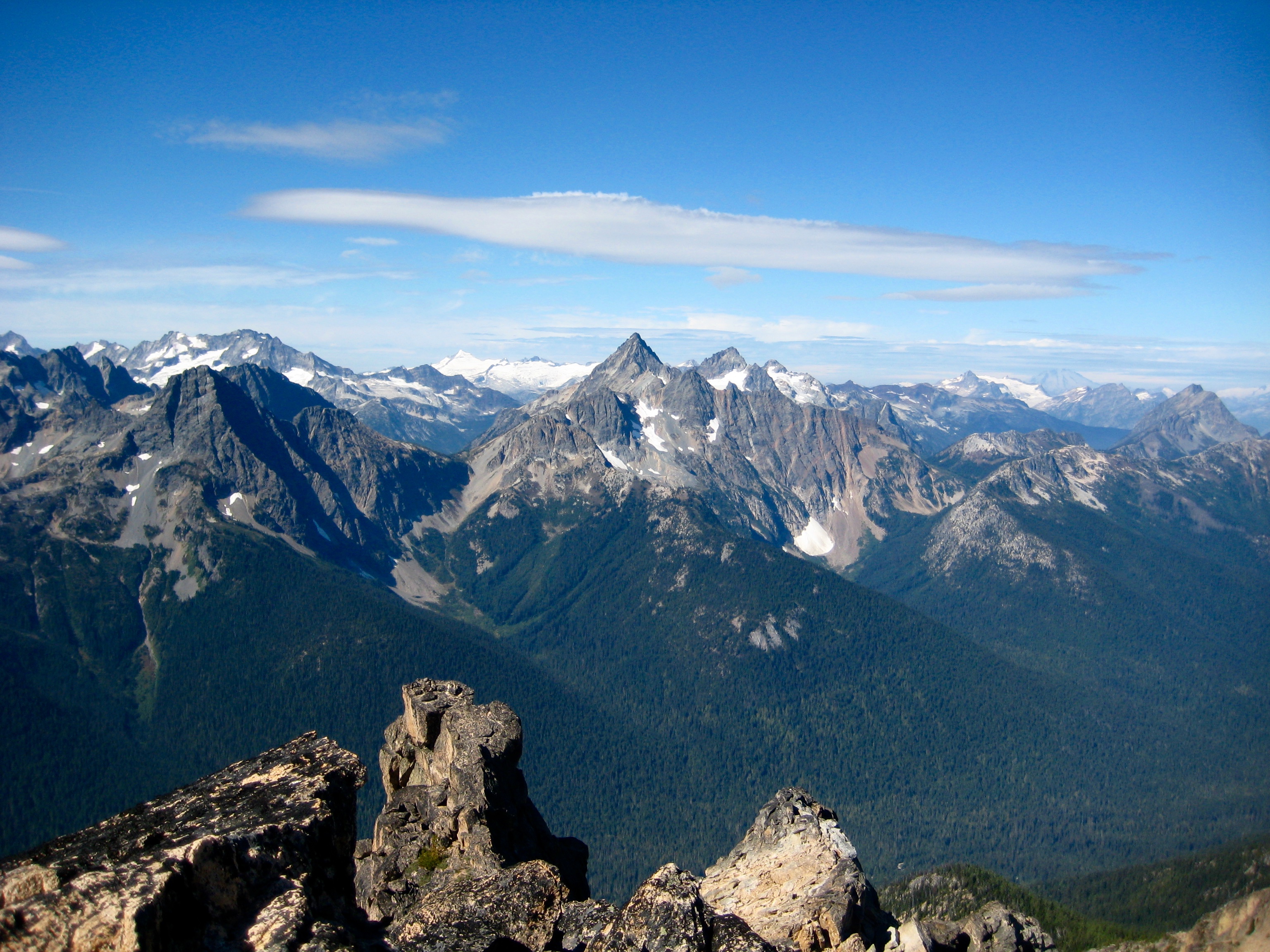 Ragged Ridge and Easy Pass fill the blue sky with the rocky boulders of Mt Hardy in the foreground
