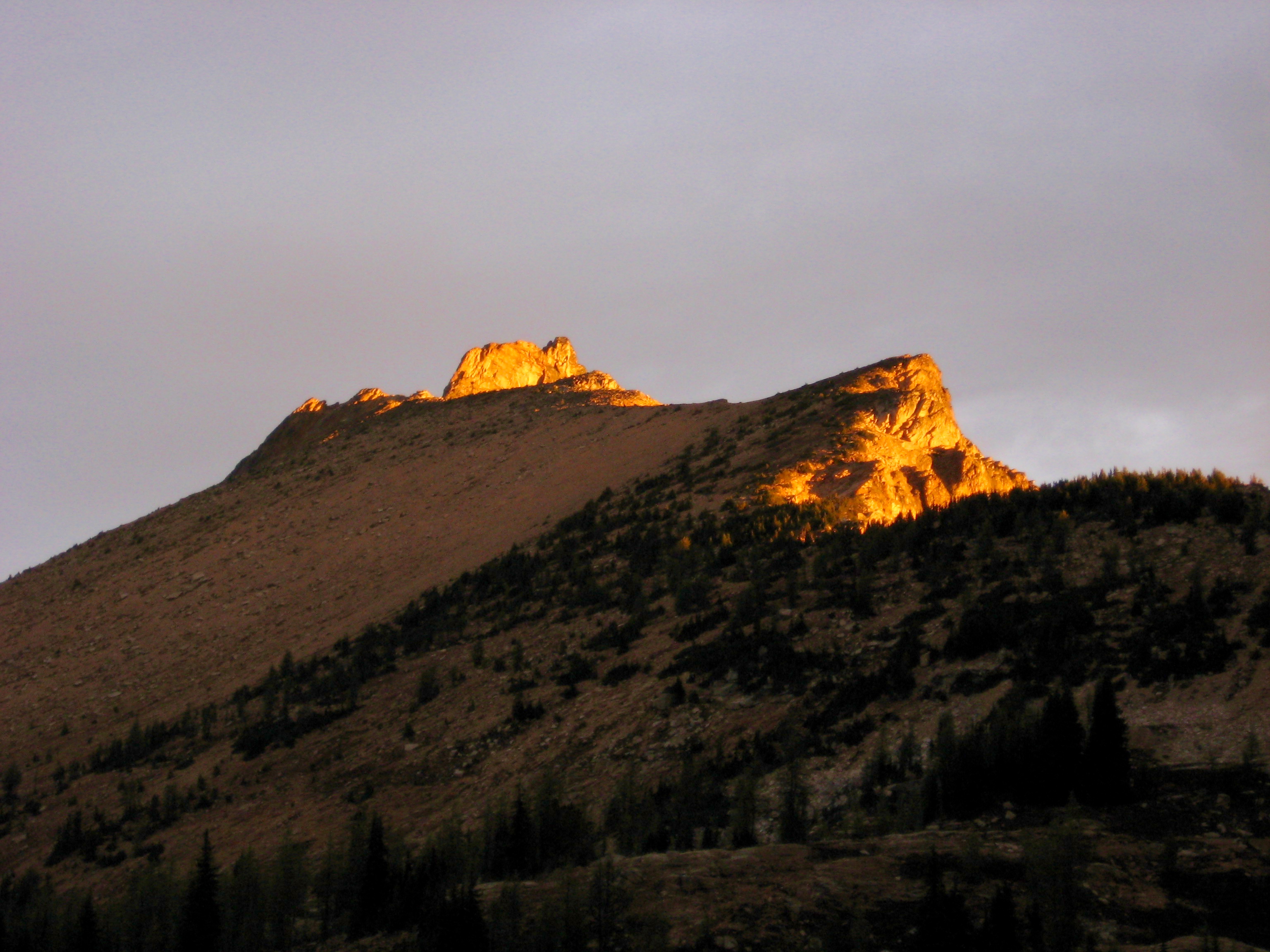 alpenglow on the sharp summit horn of Golcen Horn Peak in the Upper Methow Mountains