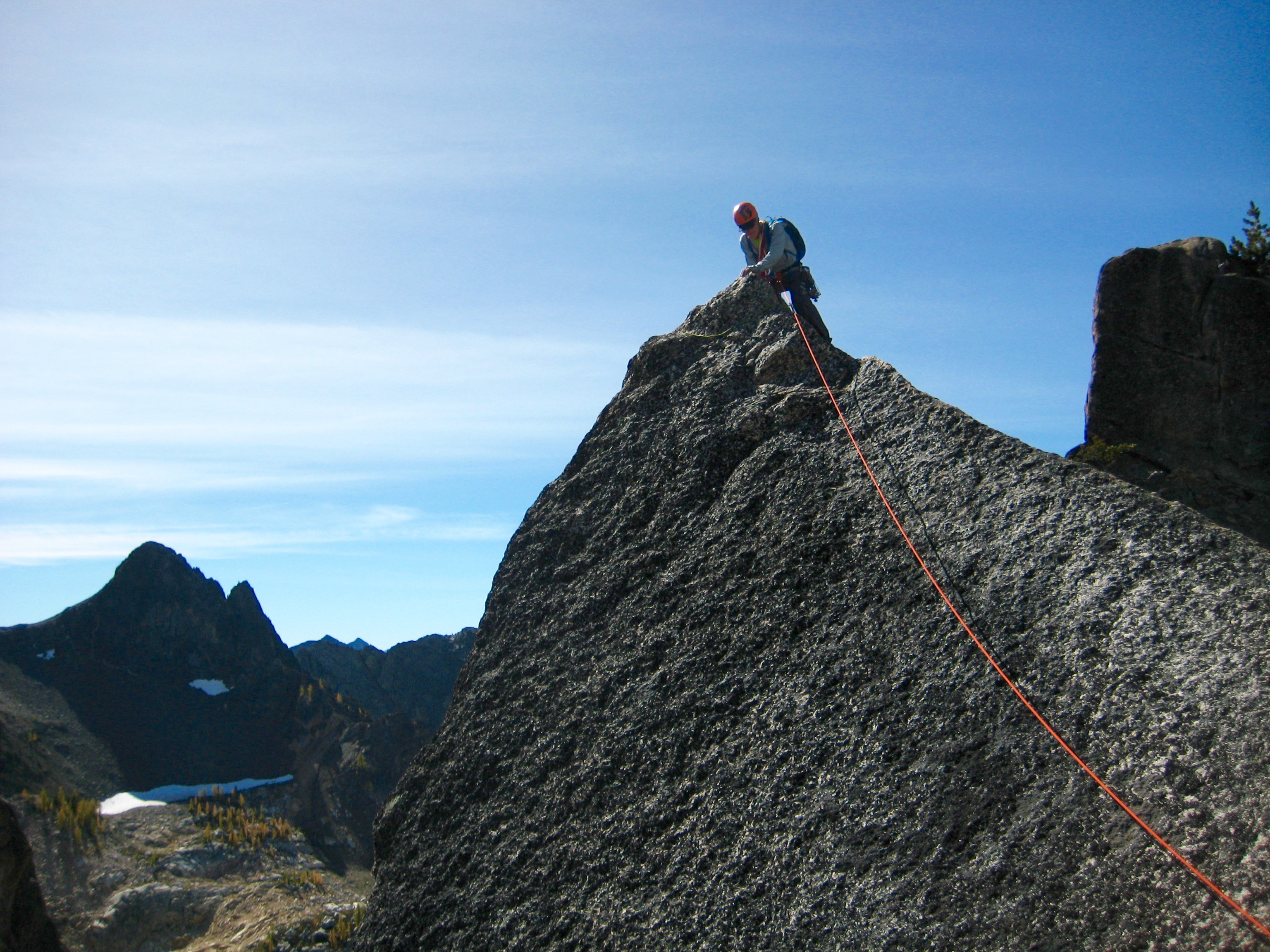 Rock Climber on Concord Tower at the Top of the Shark Fin with summit block off to the right