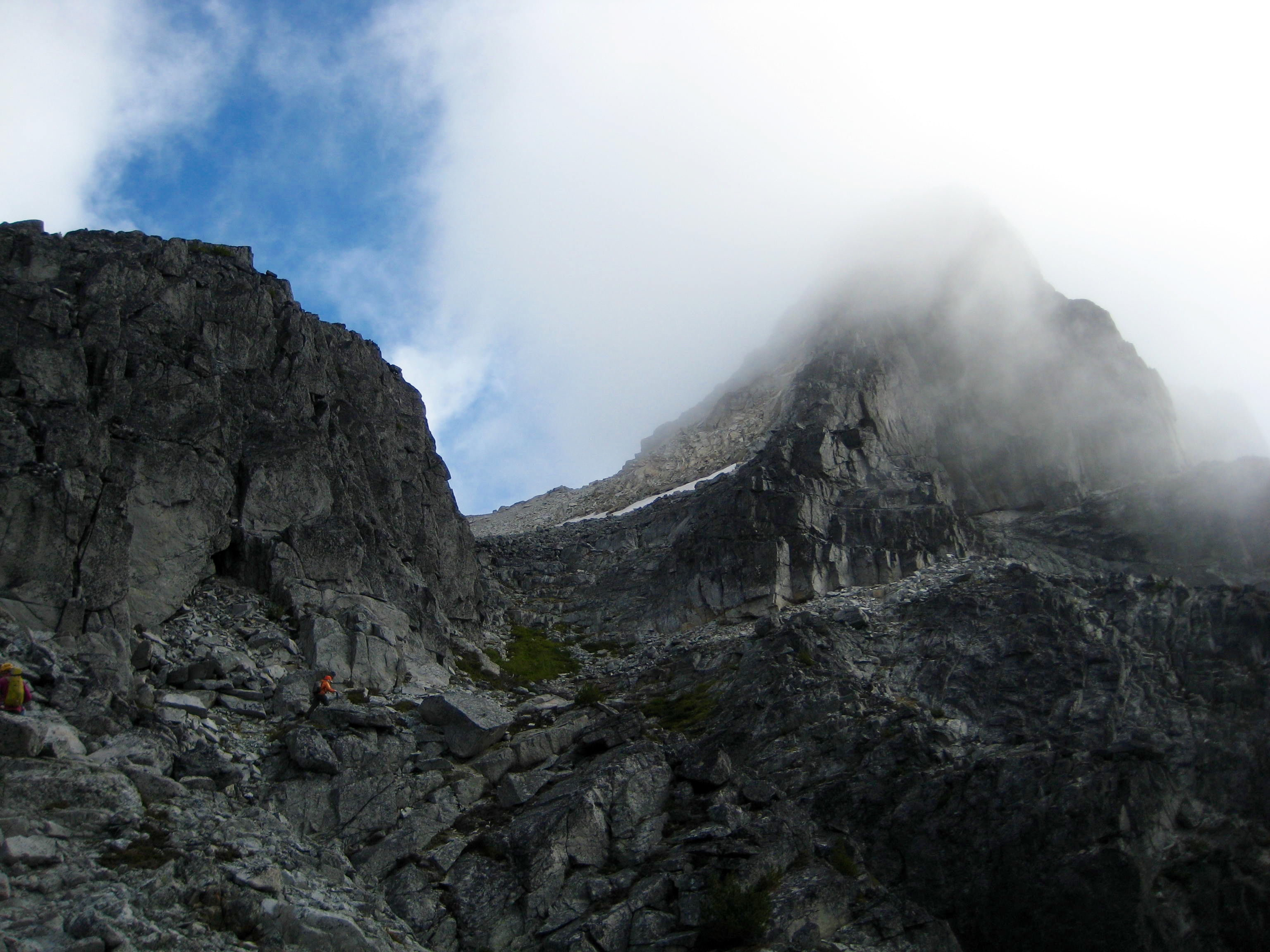 rocky, cliffy summit horn of Bear Mountain in the American Chilliwack Mountains engulfed in high fog 
