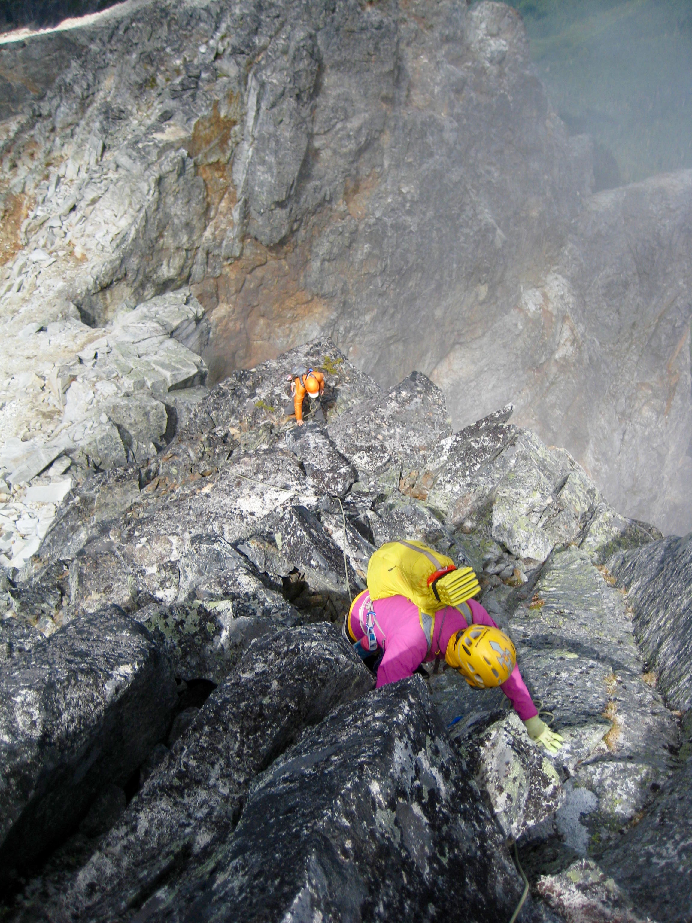 mountain climbers scrambling large boulders high on the North RIdge of Bear Mountain in the American Chilliwacks 
