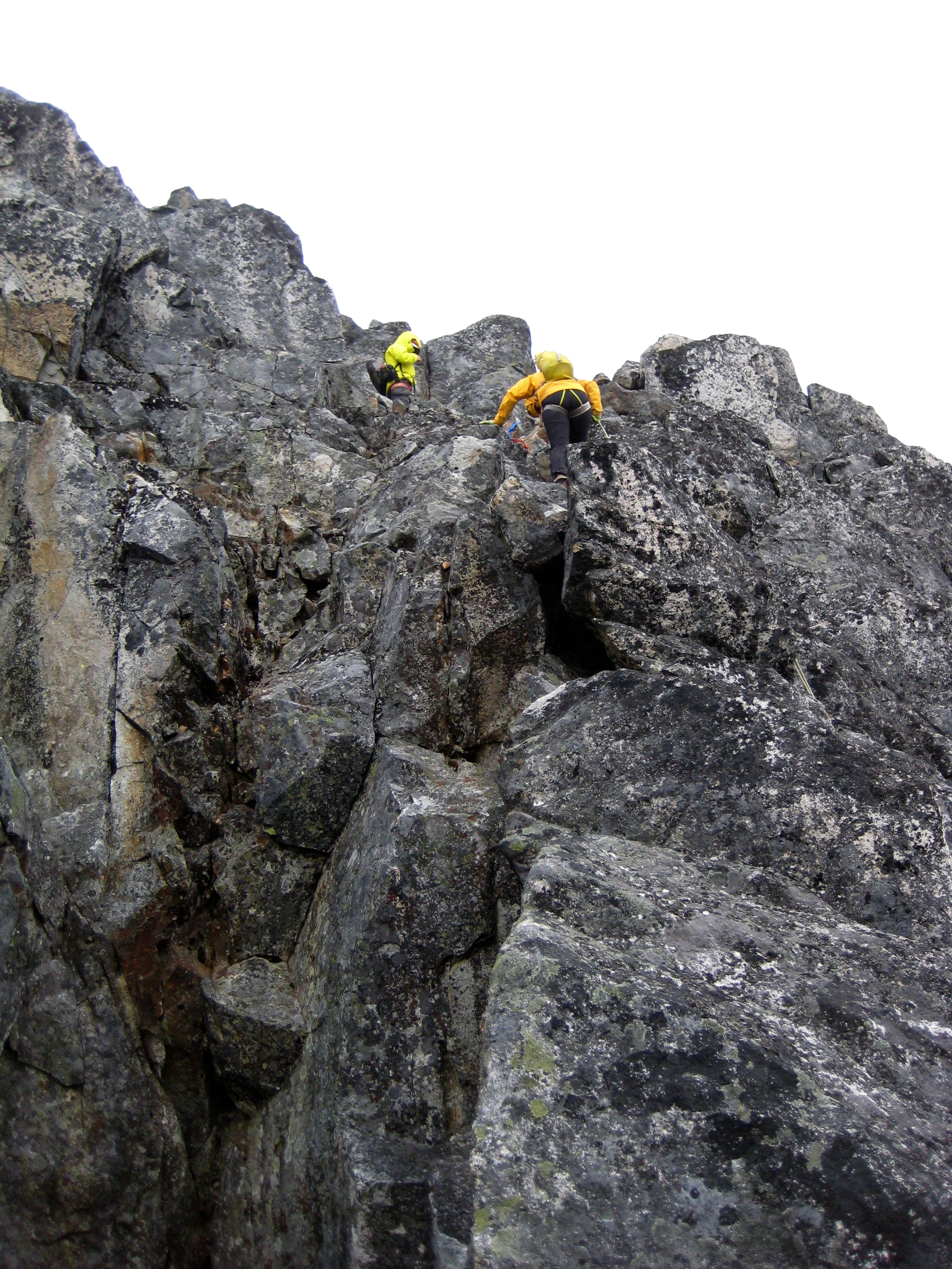 mountain climbers rappelling steep rock face of Bear Mountain in North Cascades National Park