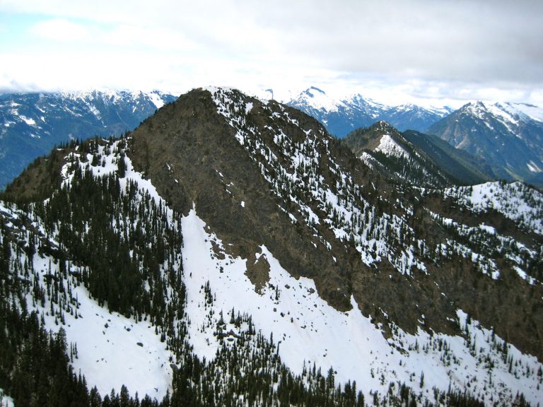 Snow chutes and rock ribs sweep upward to northwest peak of Dirtyface Mountain