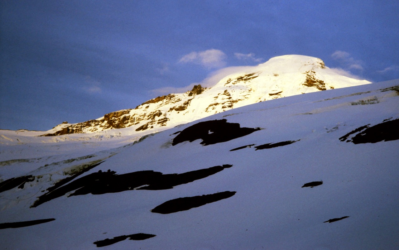 Sunlight warms the glaciated summit of Mt. Baker as seen from Heliotrope Ridge