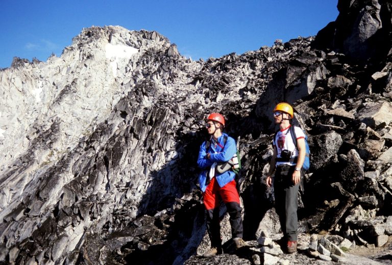 Mountain climbers stand below the summit block of Mt Stuart in the Icicle Mountains