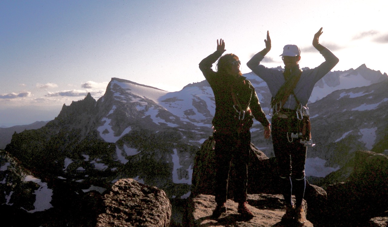 Two mountain climbers stand atop summit of Prusik Peak in the Enchantments