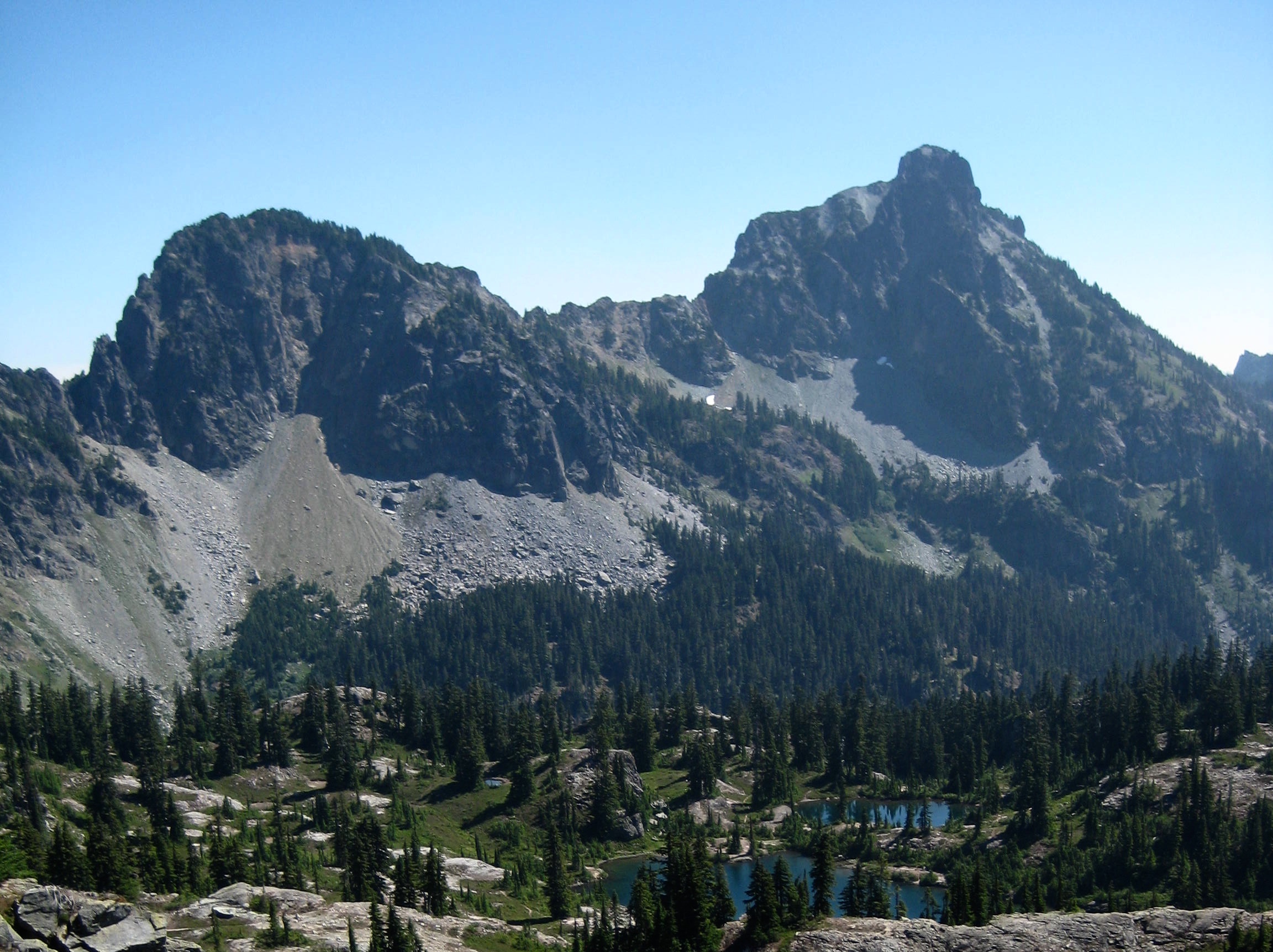 Hibox Peak in the Snoqualmie Mountains dominates the horizon with Lila Lakes sitting on a heather bench below Rampart Ridge