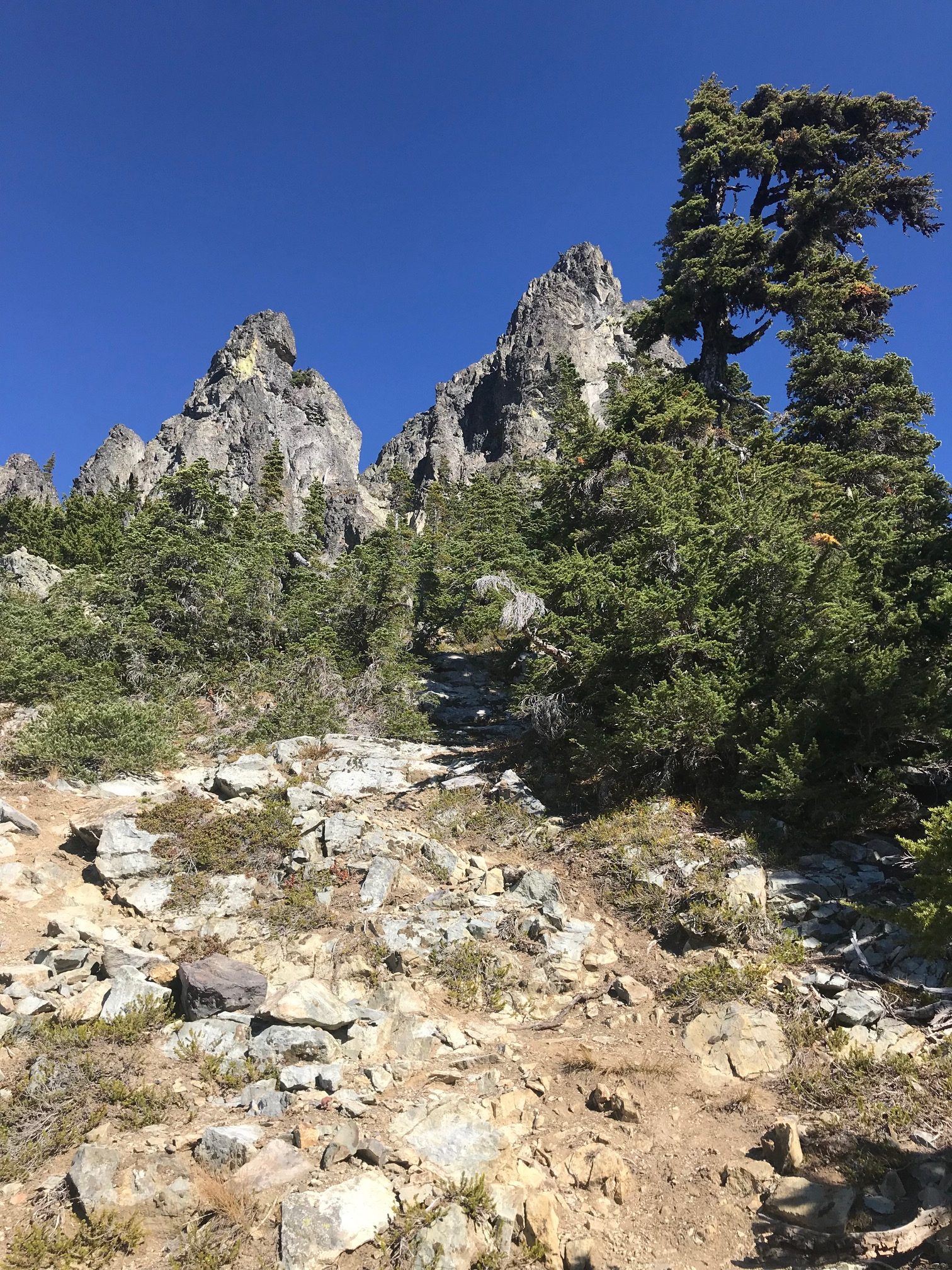 rocky summit horns of Hibox Peak with rocky, dirty climbers path in the Snoqualmie Mountains