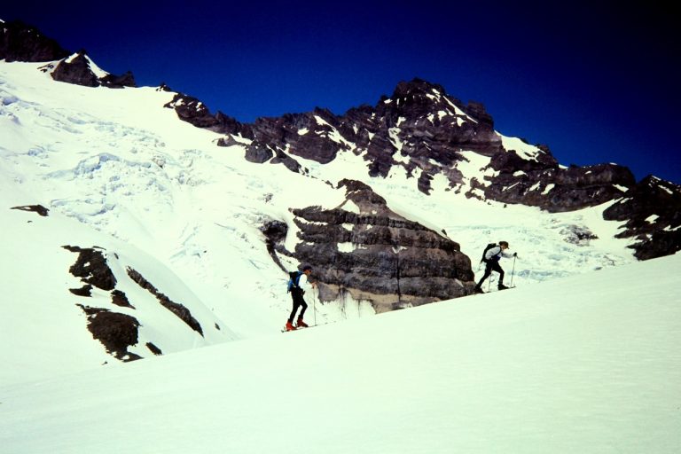 Two backcountry skiers ascending the Paradise Glacier toward Cowlitz Rocks on Mt Rainier