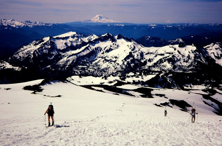 Backcountry skiers ascend Muir Snowfield to reach Camp Muir on Mt Rainier