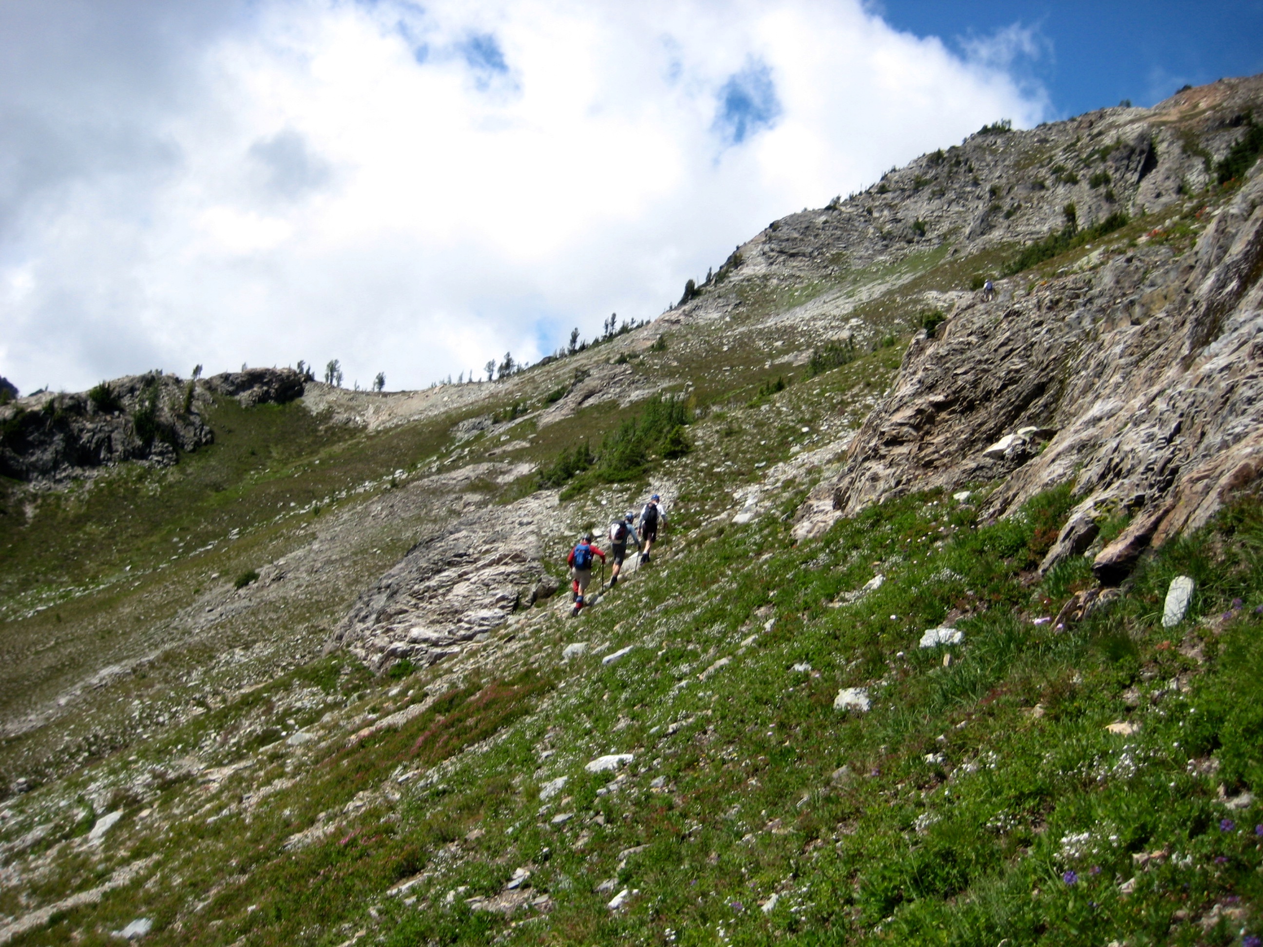 Climbers traversing hillside towards 7200-Foot Saddle Below Mt Arriva