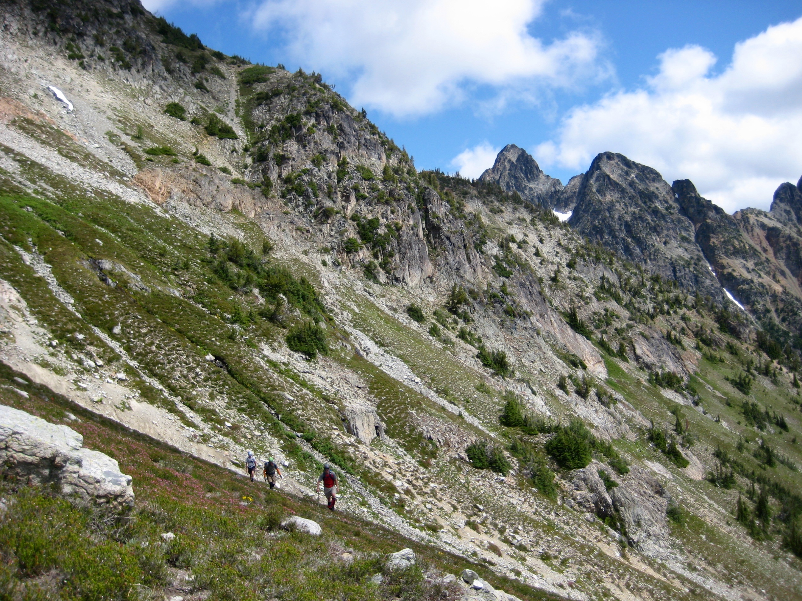 Climbers traversing hillside toward Mt Arriva