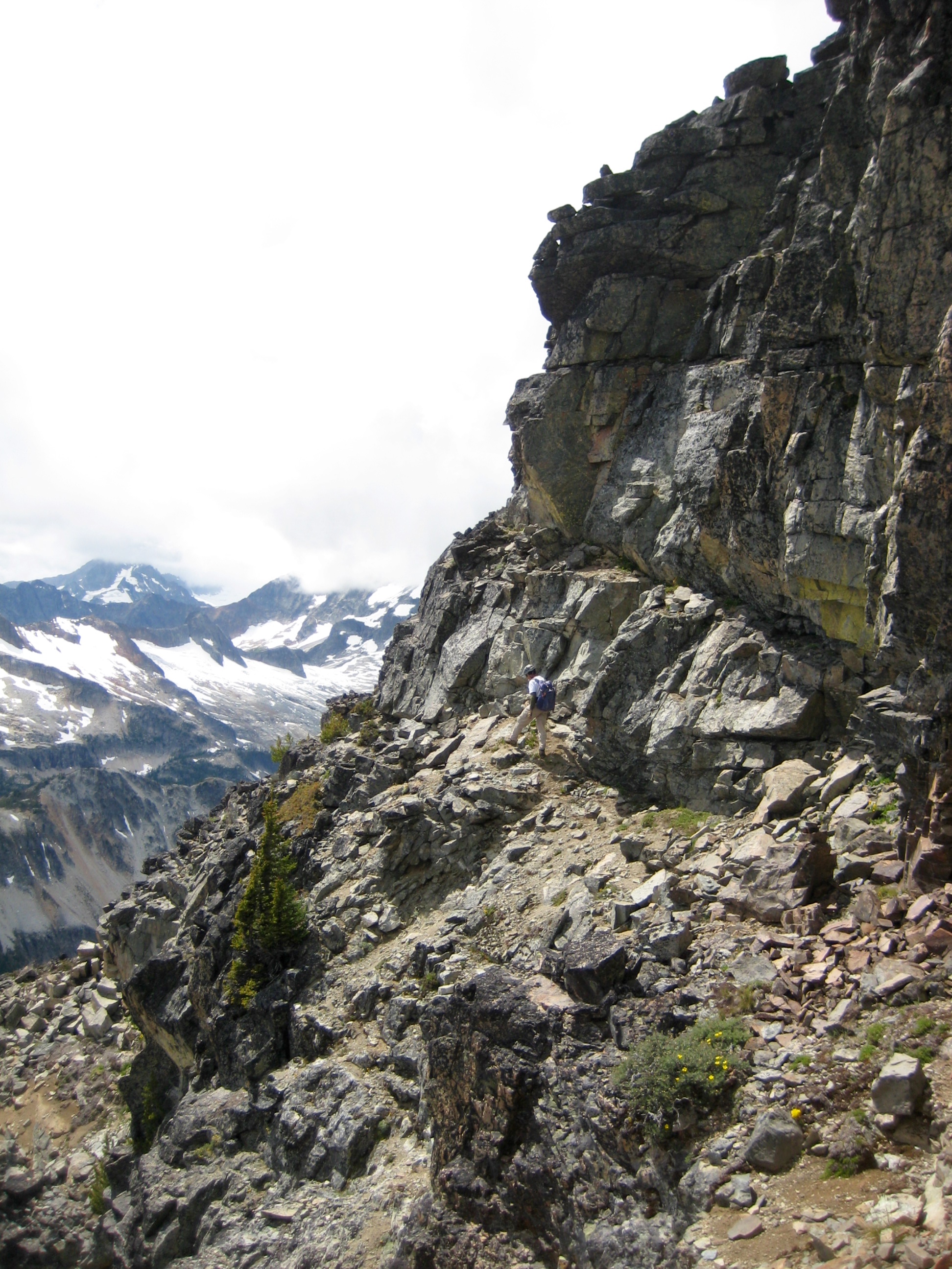 Climbers traversing around the upper ledges below the summit of Mt Arriva
