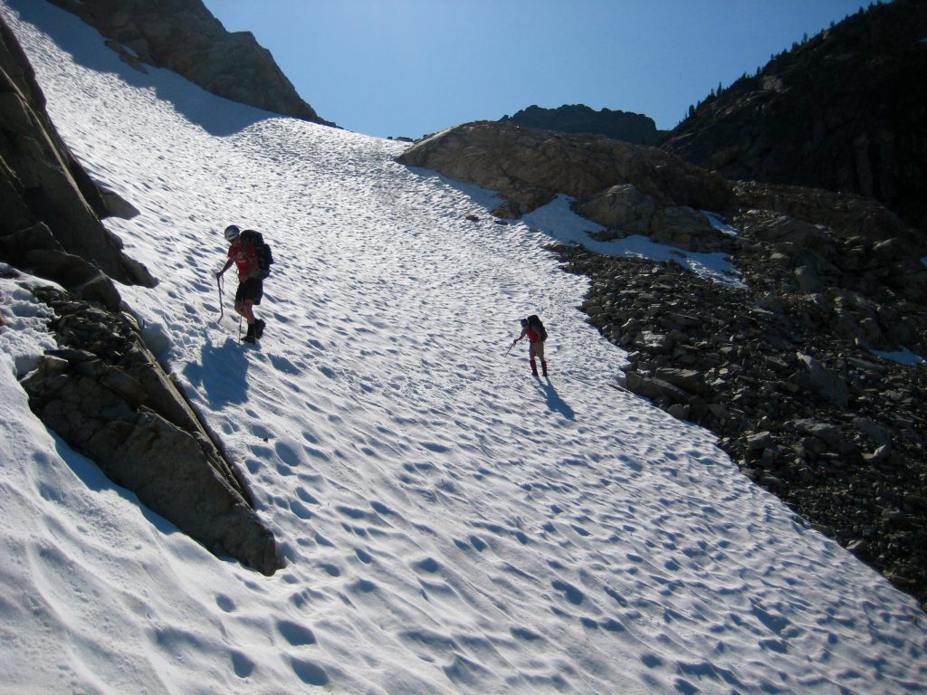 Climbers crossing steep snow below Silent Pass and Silent Lakes