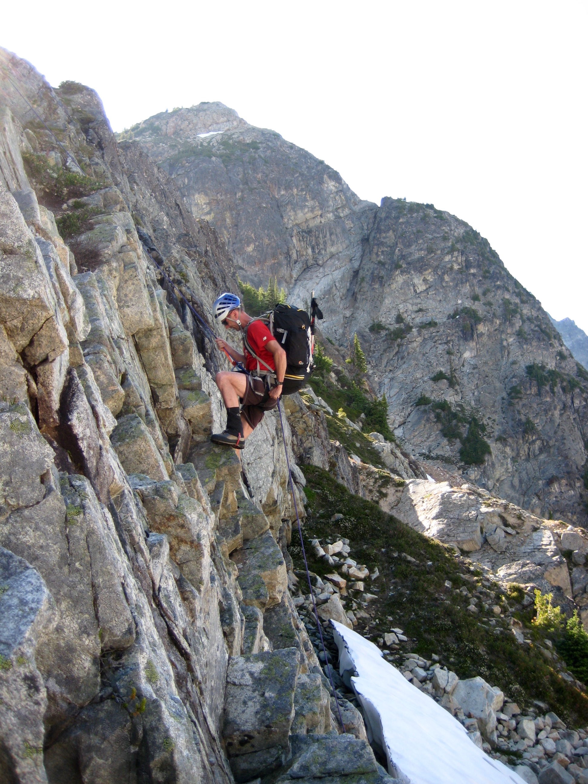 Todd rappelling over the Cliff Band with Mt Arriva