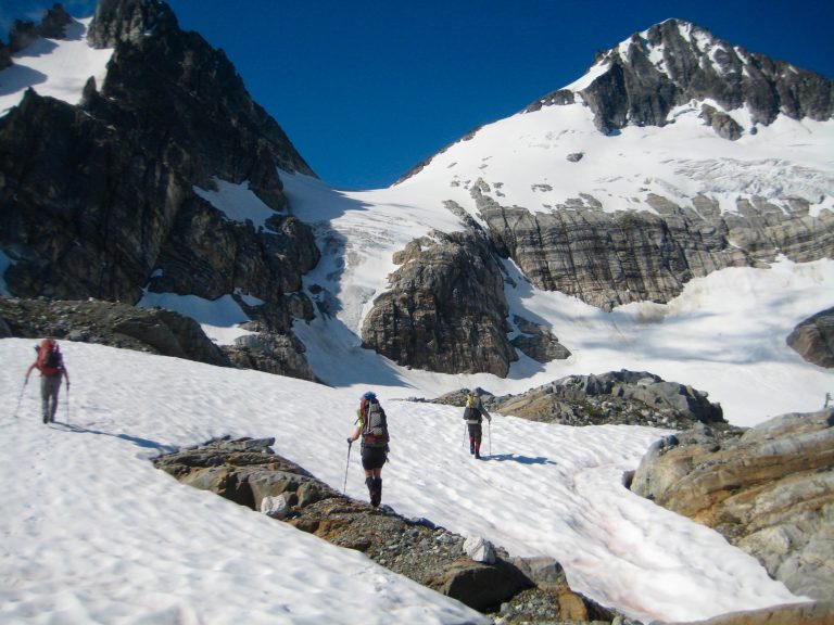 Mountain Climbers on snow hiking toward Borealis Pass and McAllister Traverse aka Inspiration Traverse