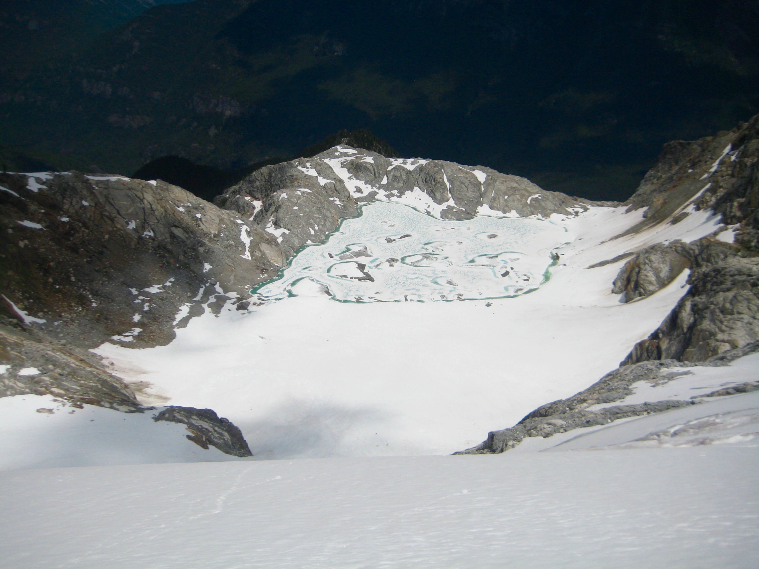 Looking down on Borealis Lake in the North Cascades from Borealis Glacier on McAllister Traverse aka Inspiration Traverse