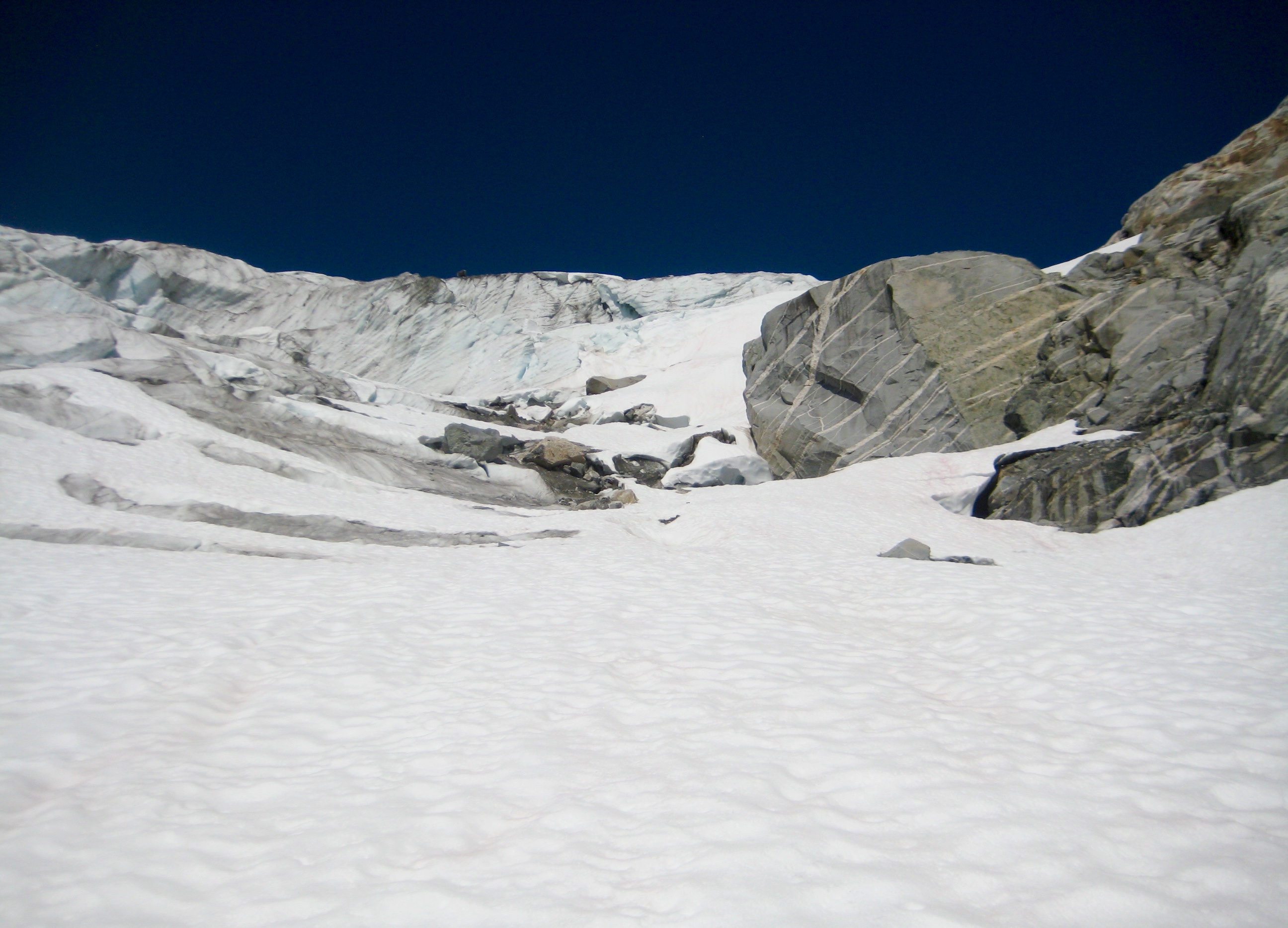 Large snow field leading up North Klawatti Glacier snout along McAllister Traverse aka Inspiration Traverse in the North Cascades