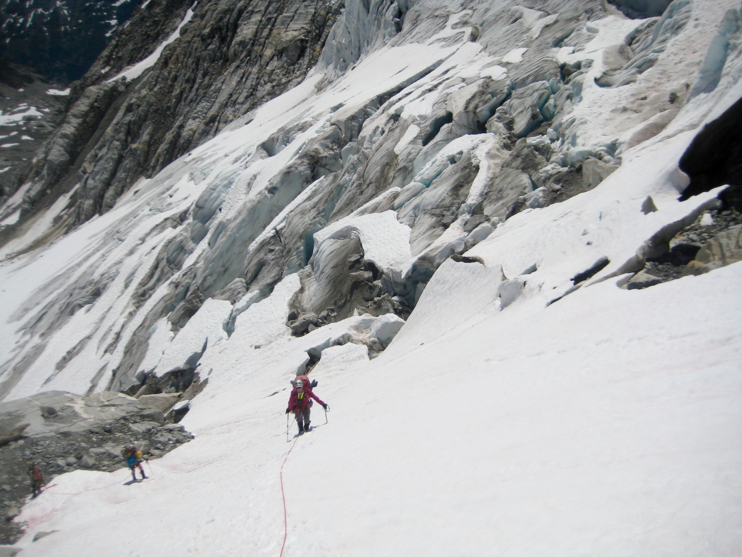 roped mountain climbers ascending snow feild after crossing North Klawatti Glacier Snout on McAllister Traverse aka Inspiration Traverse in the North Cascades