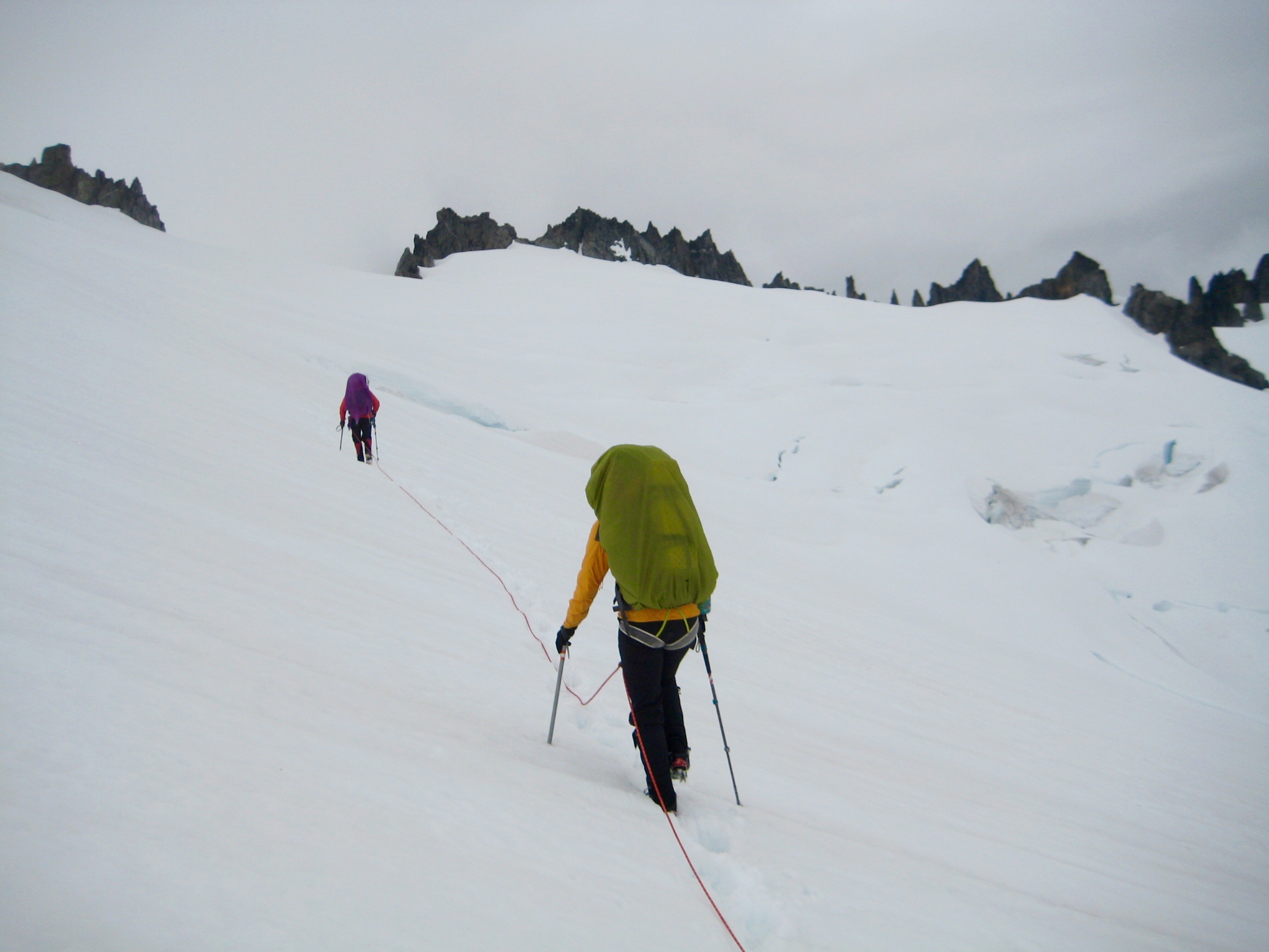Mountain Climbers crossing Inspiration Glacier towards Tepeh Gap and Tepeh Towers on McAllister Traverse aka Inspiration Traverse