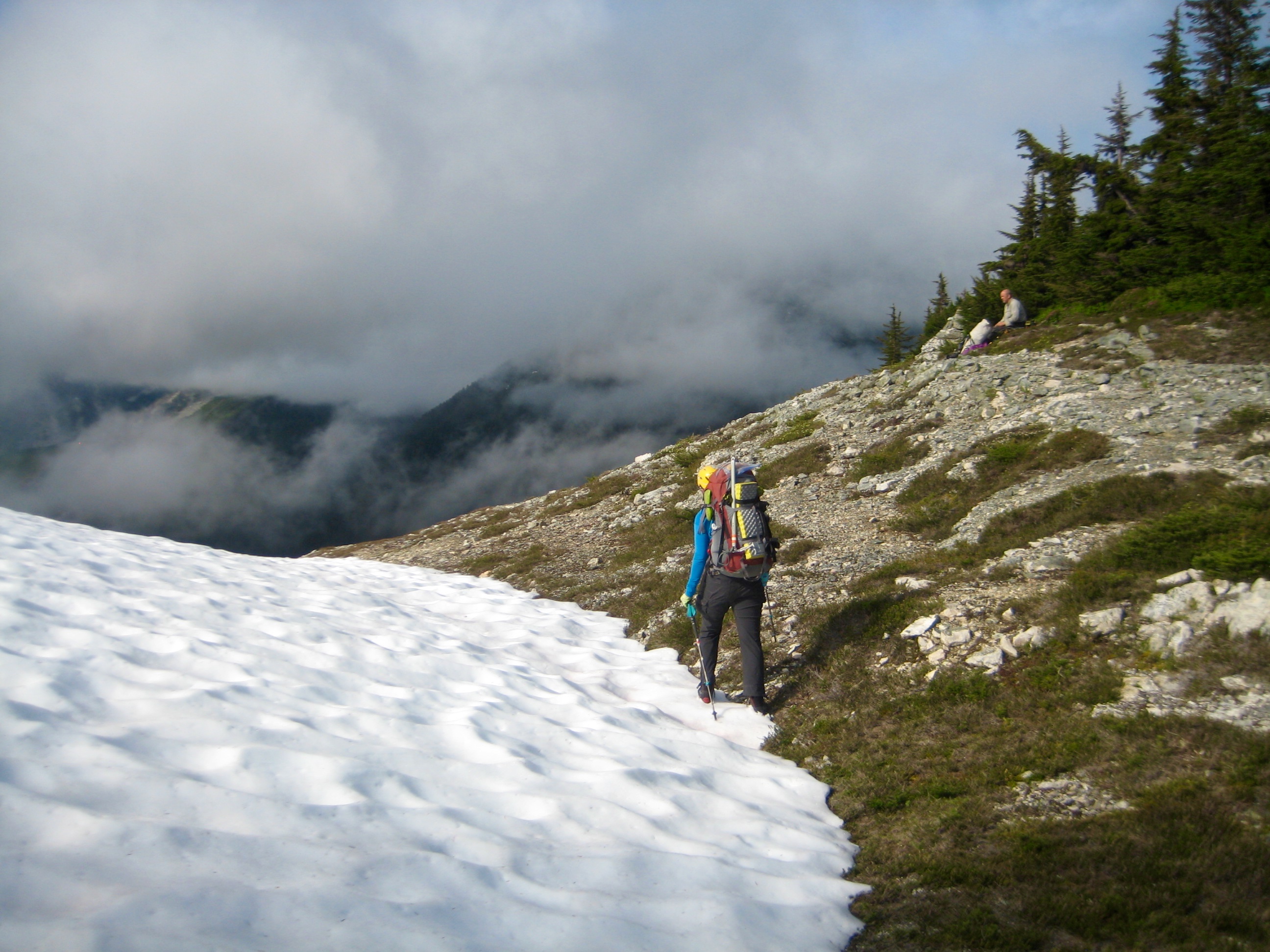 Climber on snow patch crossing over Wilcox Pass on McAllister Traverse aka Isolation Traverse