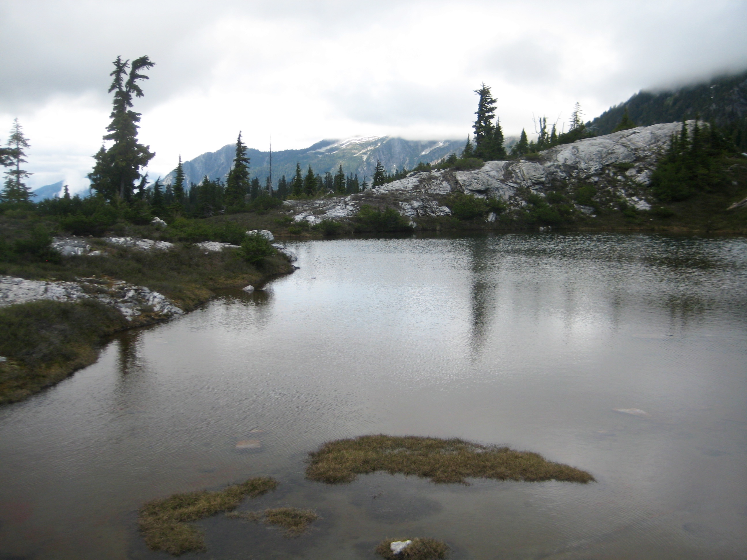 morning light with high clouds on Wilcox Tarns in the North Cascades along the Isolation Traverse