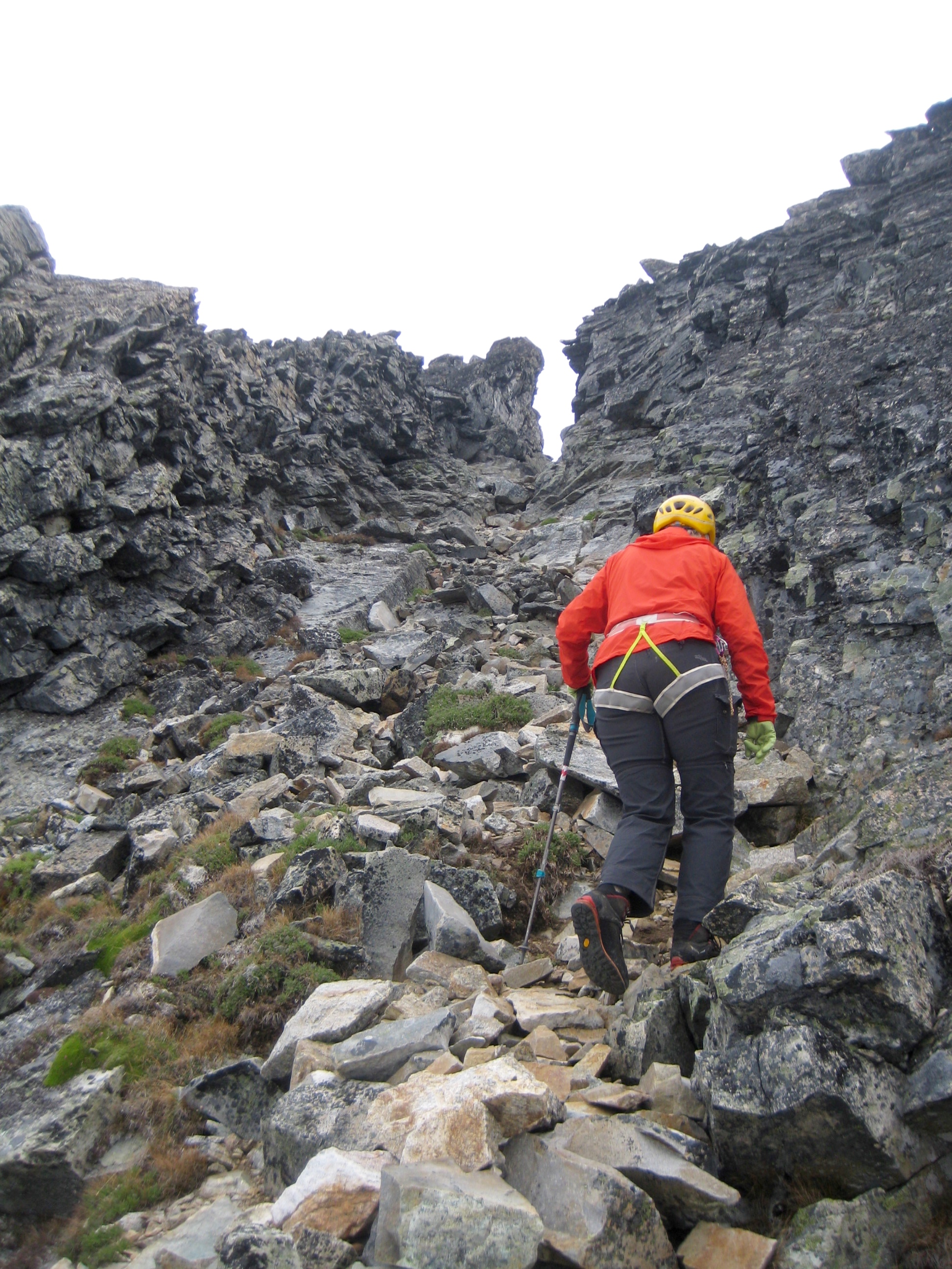 mountain climber hiking up rocky shoulder on Snowfield Peak in the North Cascades