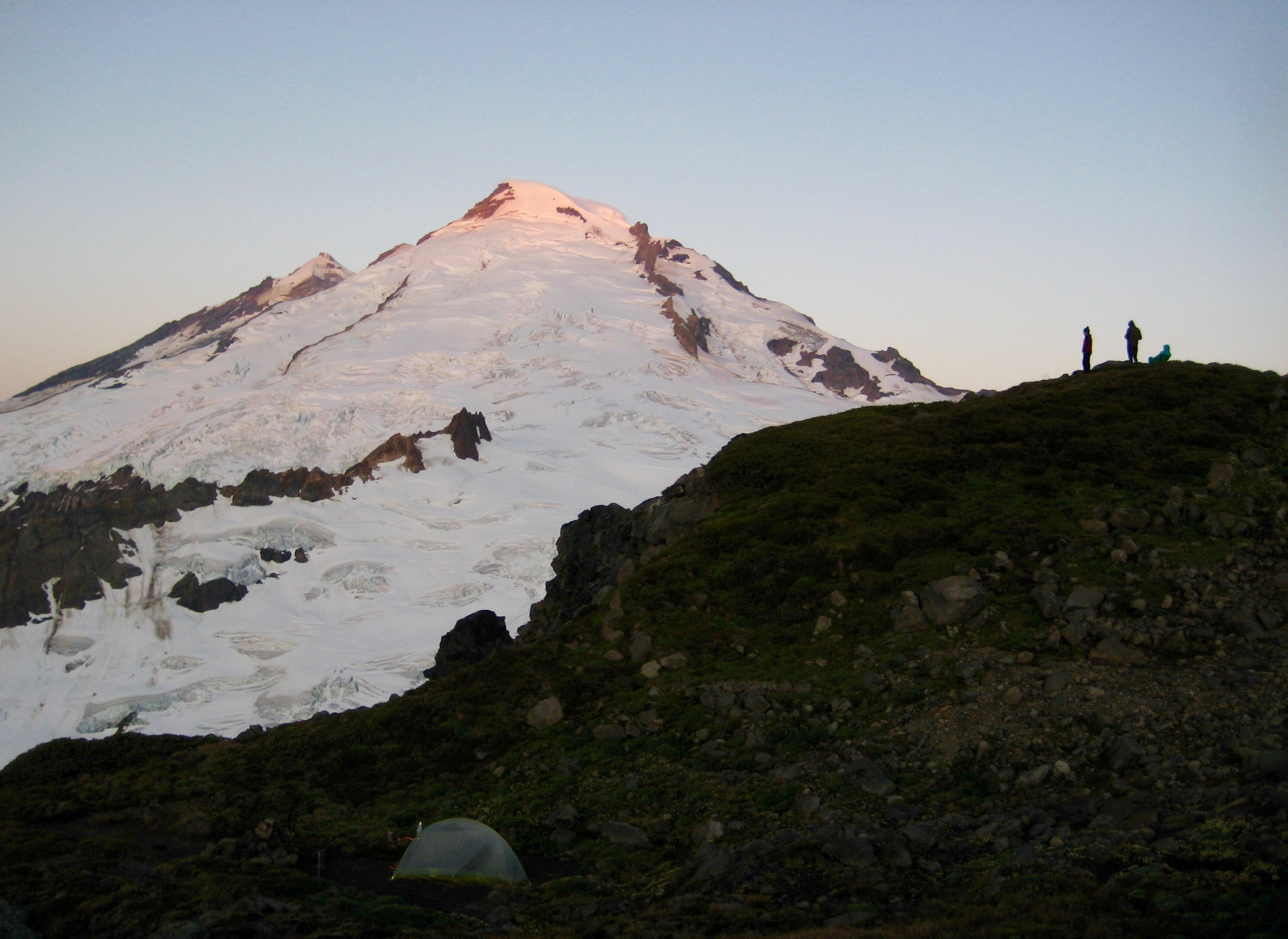 Sunrise on Mount Baker with camp on a rocky knoll near East Portal Peak