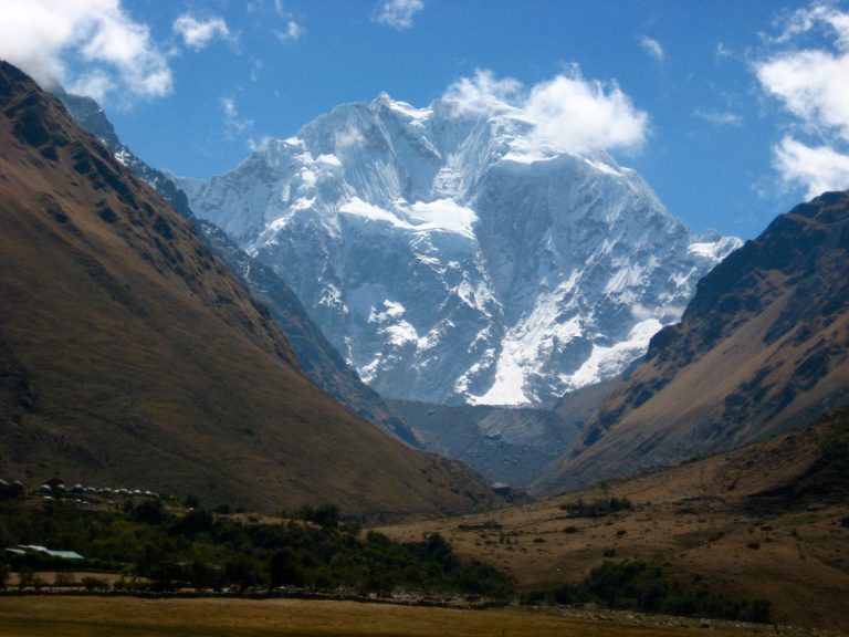 Nevado Salkantay in Peru Towering Above Soraypampa with grassy slopes during Salkantay Trek