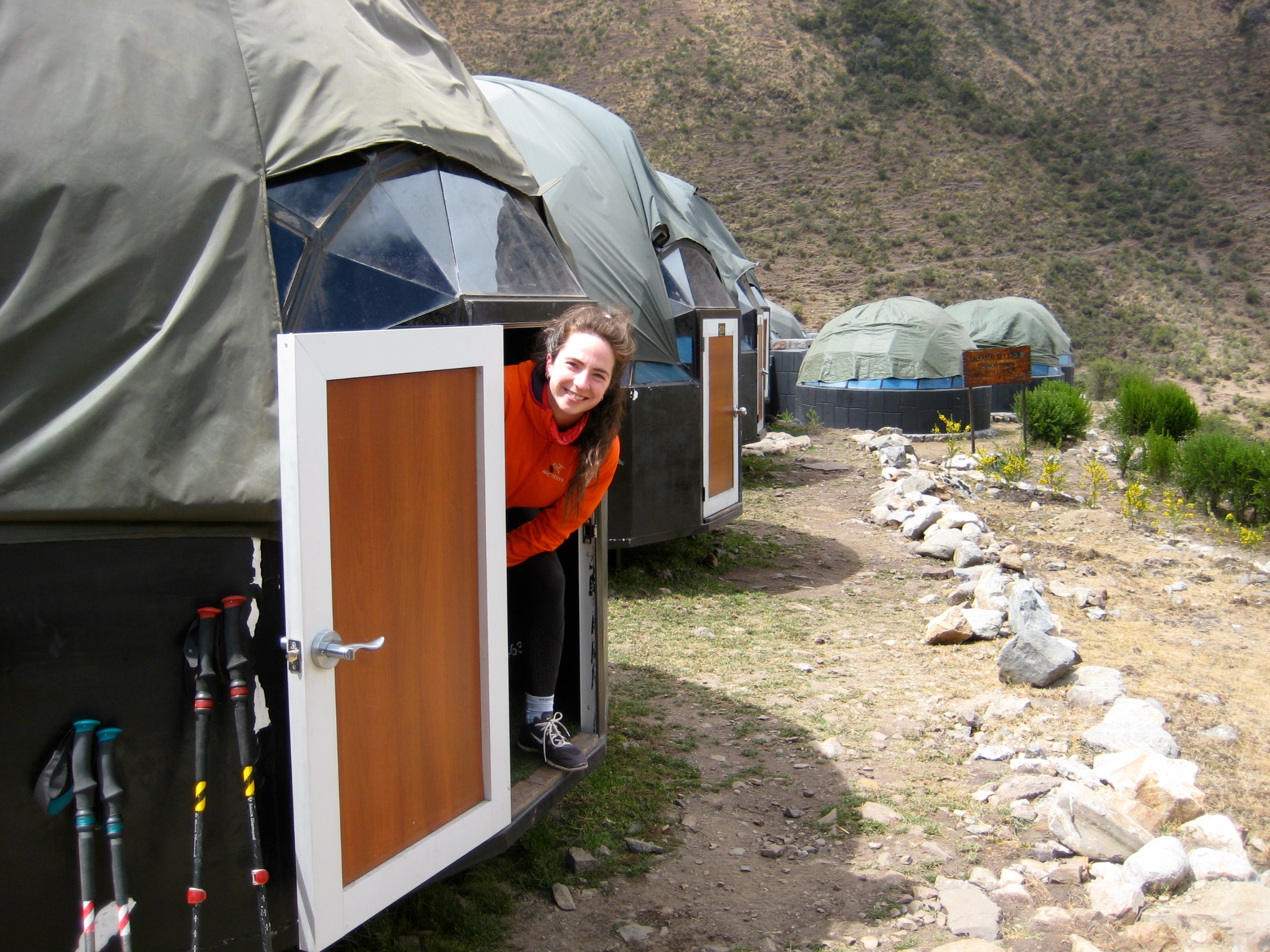 trekker sticking there head out of the Sky Camp Hut on the Salkantay trek