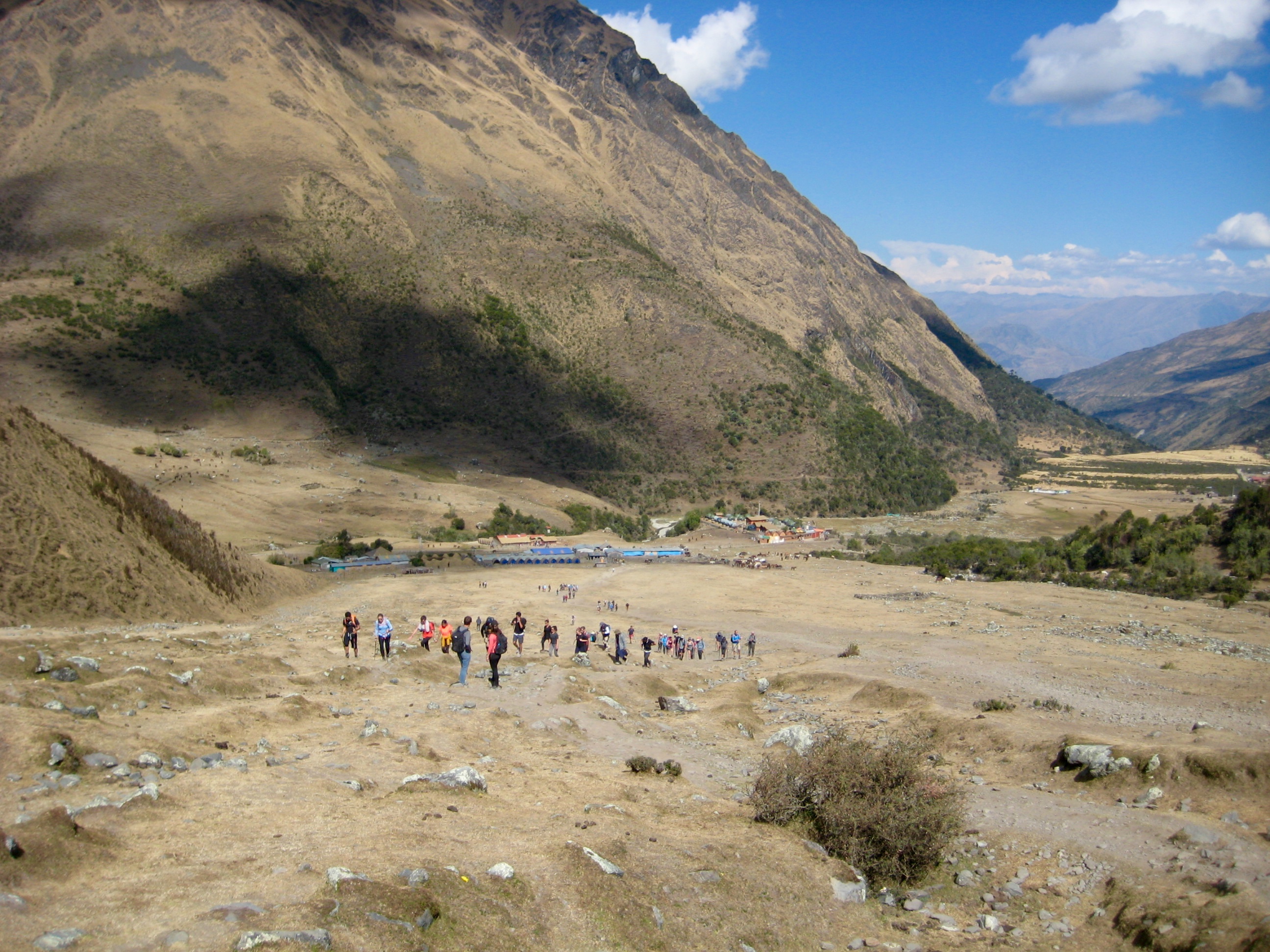 trekkers hiking up rocky slope to Lake Humantay