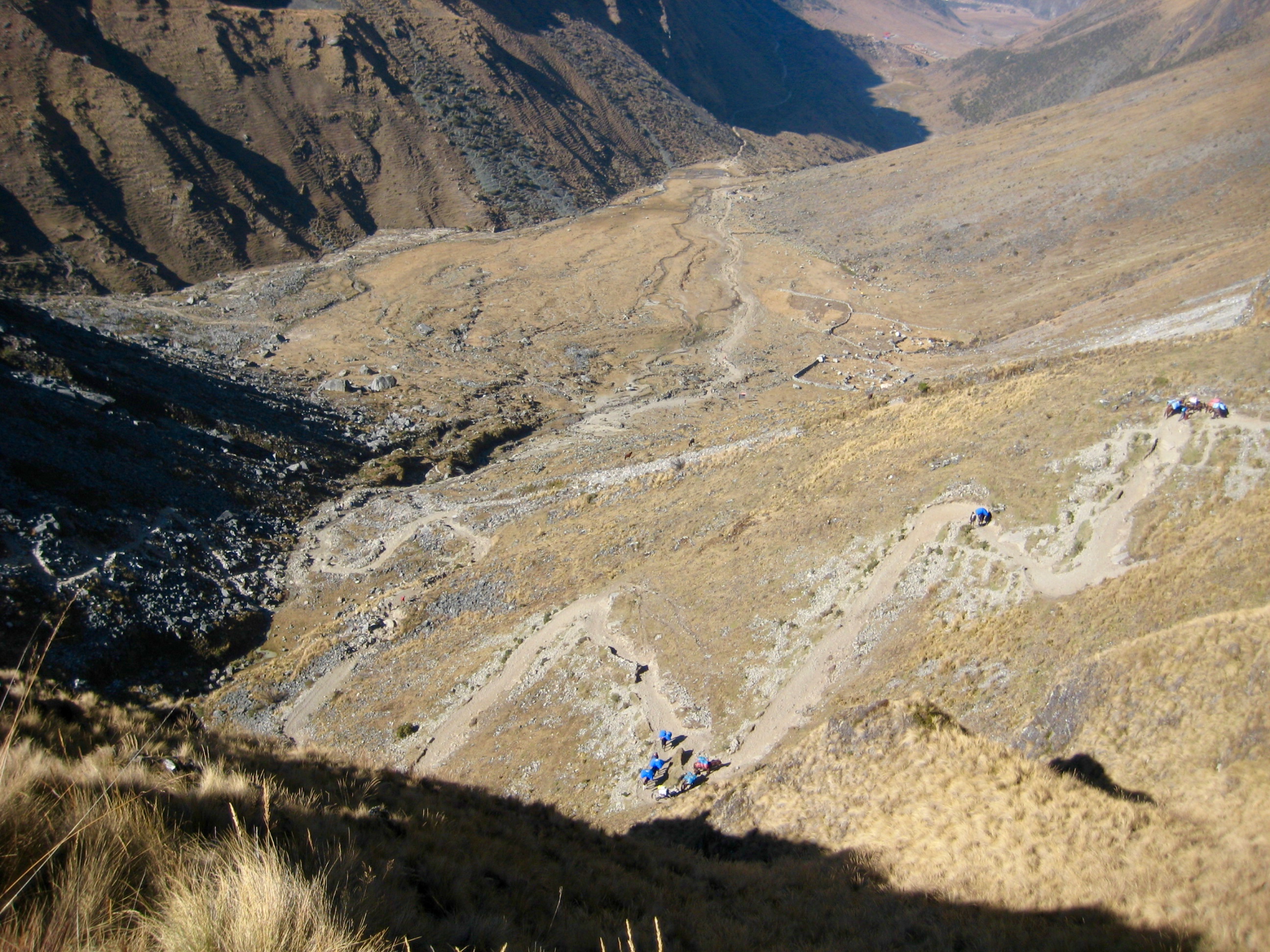 Looking down rocky slope with lots of trekkers heading up the Seven Snakes Switchboacks