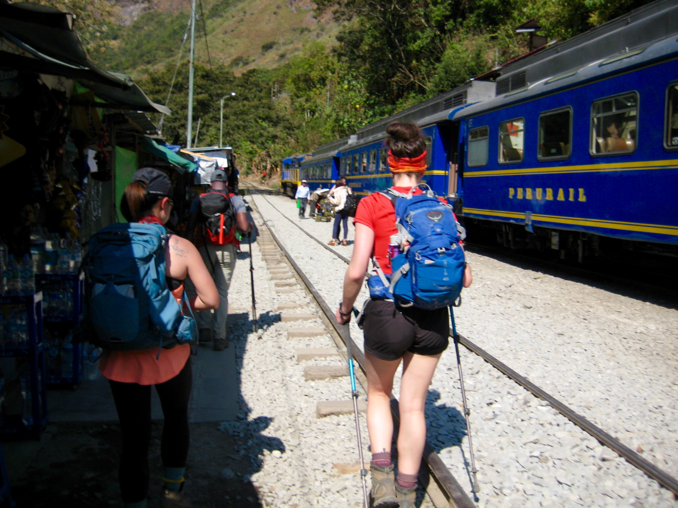 trekkers hiking thru the train depot at Hidroelectrica with a parked train
