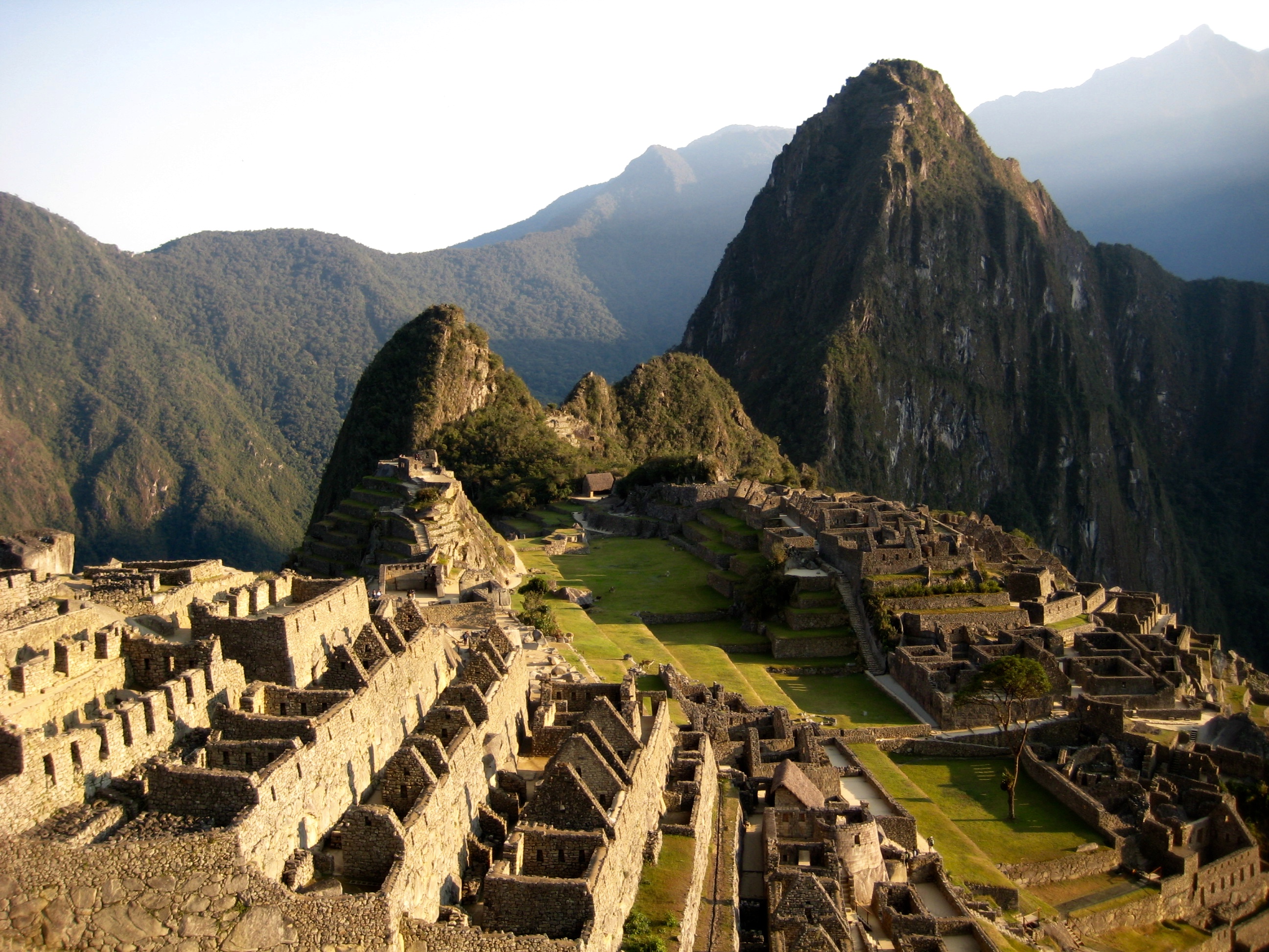 Machu Picchu Village and Wayna Picchu Mountain from high on the hillside at sunrise