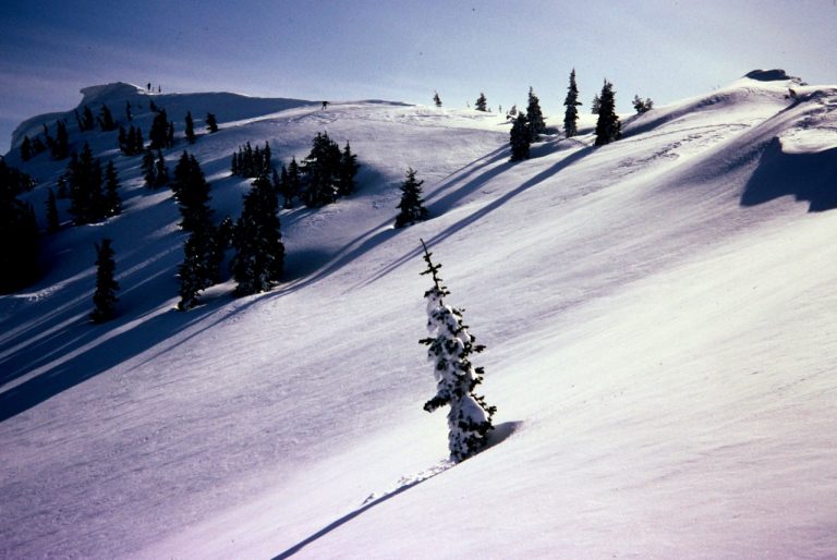 A snowy ridge leads up to the broad summit of Jolly Mountain