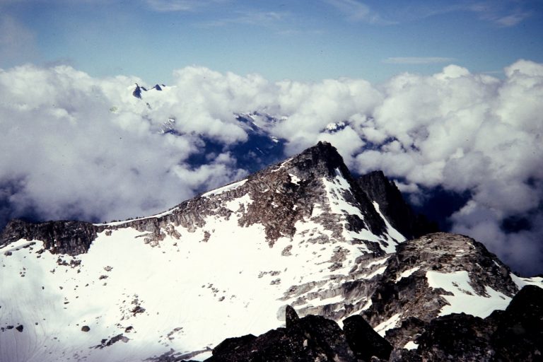 Clouds swirl around Hidden Lake Peak Lookout in the North Cascades