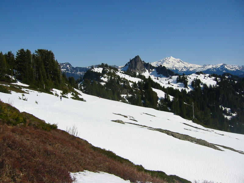 Snow slopes on Stillaguamish Peak lead toward a mountainous horizon