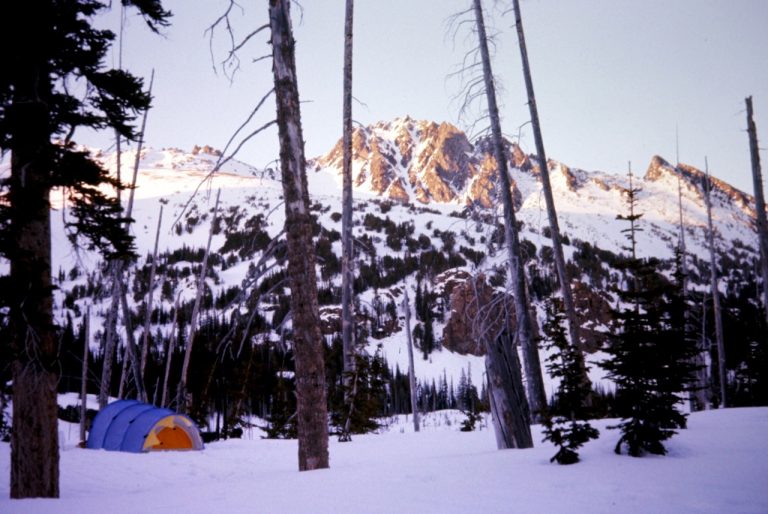 Cashmere Mountain can be seen between trees from a camp near Lake Caroline in the Alpine Lakes Wilderness