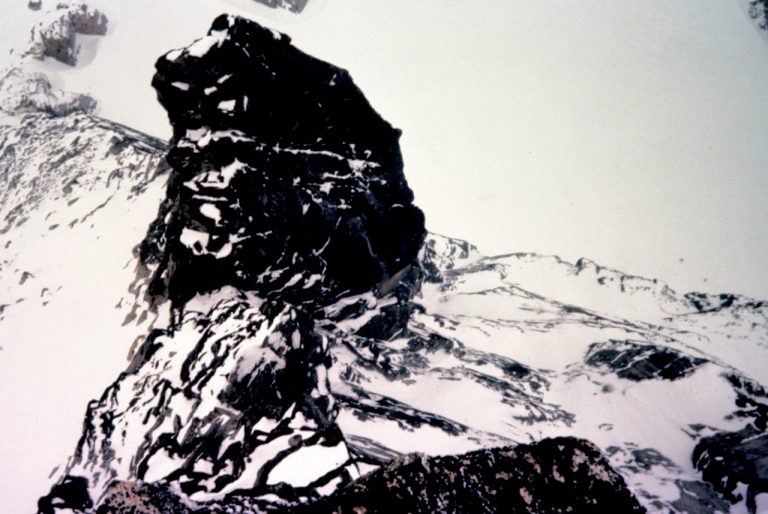 Fresh snow covers Bull Durham Tower as viewed from Rooster Finch Tower near Dragontail Peak