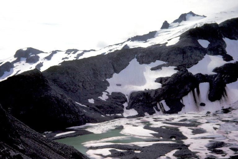 Looking across ice-covered Pea Soup Lake at Mt Daniel from Dip Top Gap in the Alpine Lakes Wilderness