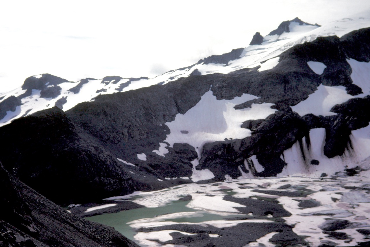 Looking across ice-covered Pea Soup Lake at Mt Daniel from Dip Top Gap in the Alpine Lakes Wilderness