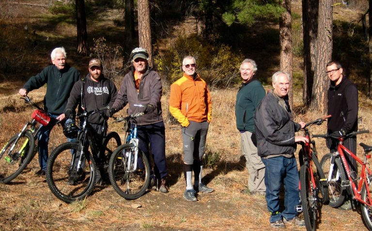 Group of mountain bikers with their bikes getting ready to descend the East Mission Gulch