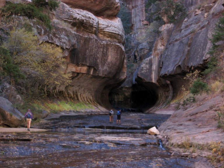 Canyoneers enter The Subway, a rock tunnel in Zion National Park