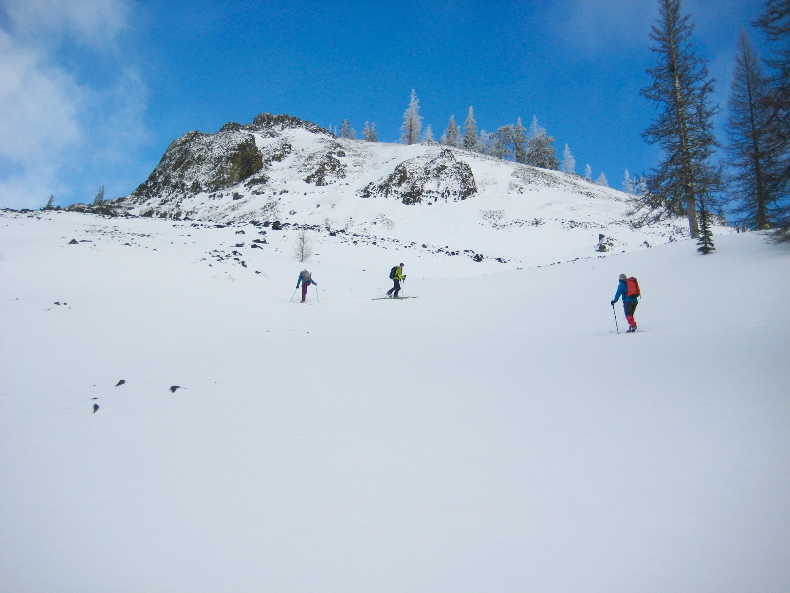 skiers skinning up Windy Hollow snowfield below Windy Knob on the first half of the Tronsen Head Ski Loop