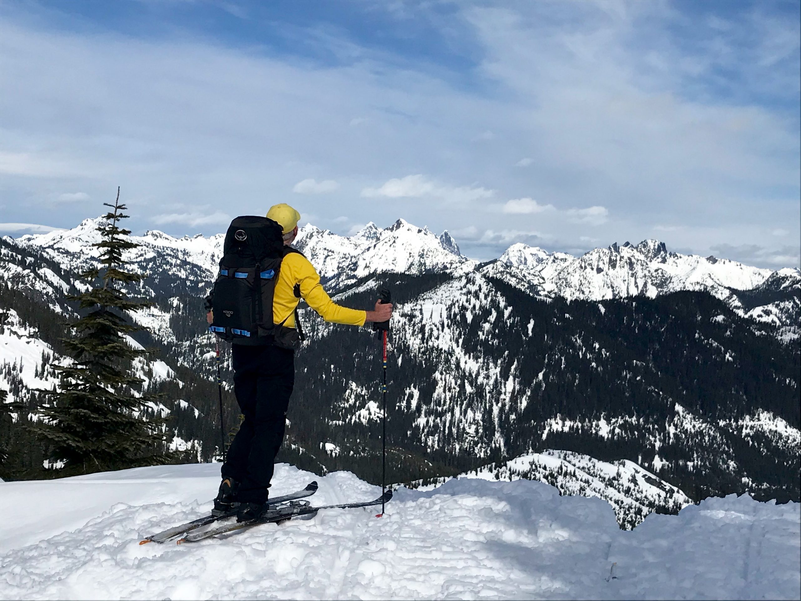 Jim skiing with Hibox Peak and Three Queens Mountains in the distance from Keechelus Tower Knoll in the Keechelus Mountains