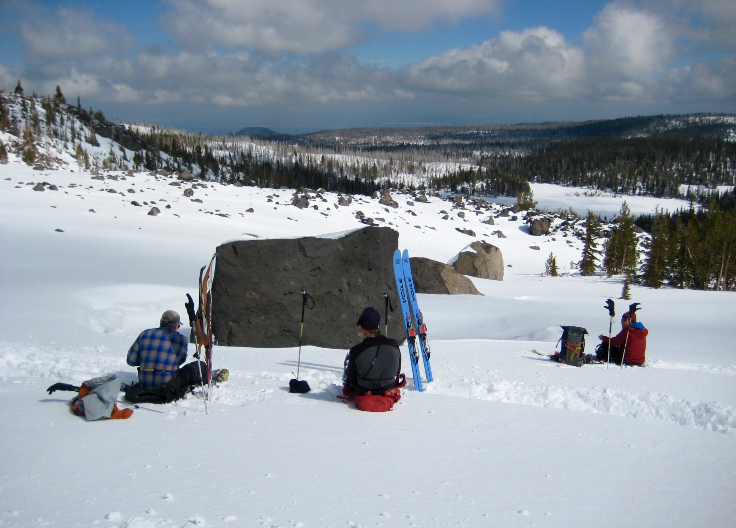 Skiers taking lunch break in Yahtzee Bowl on Tam Rim